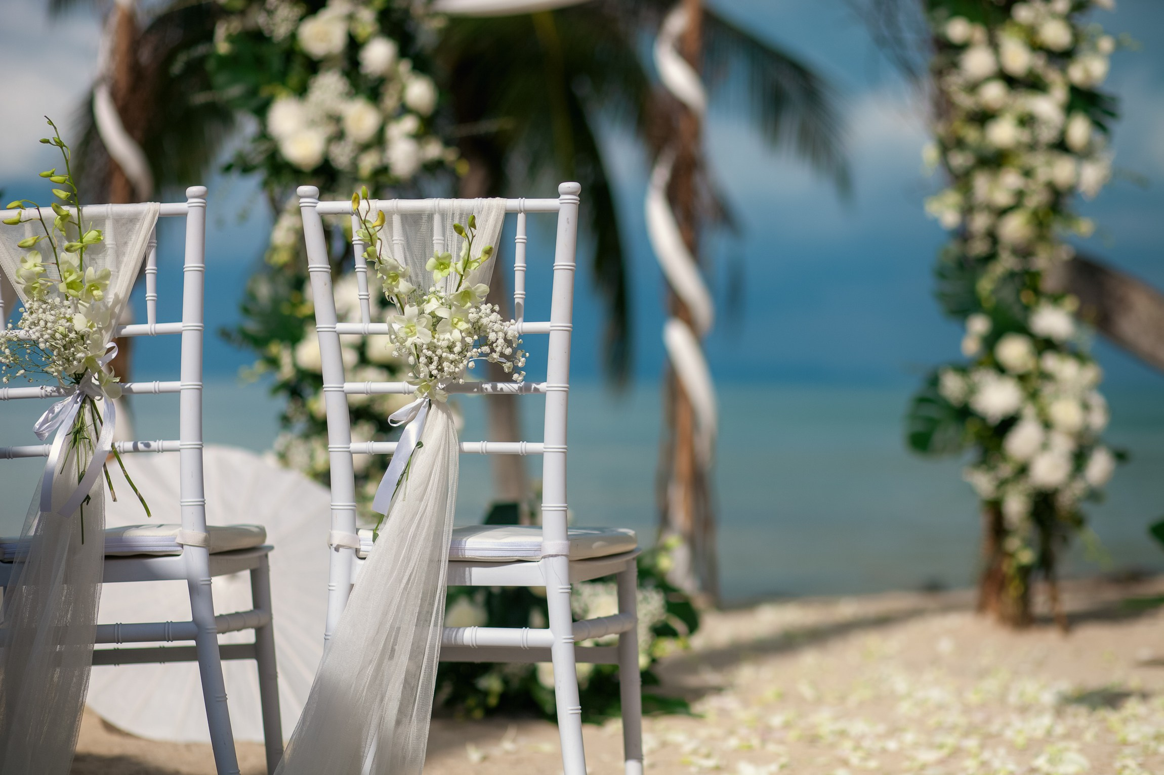 Couple celebrating a private destination wedding for two on a sandy beach in Koh Samui, Thailand