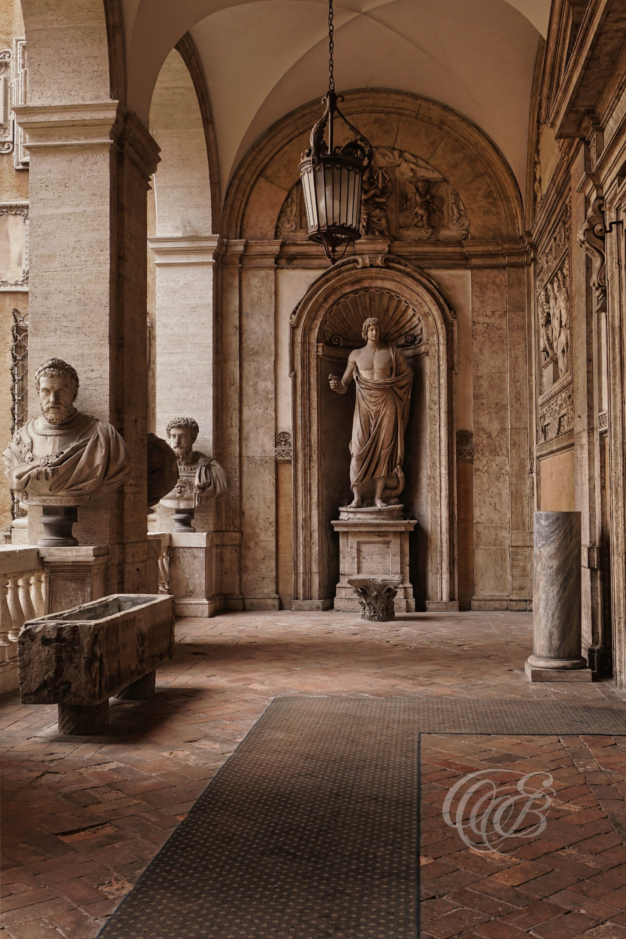 ITALY TRAVEL PHOTOGRAPHY – ITALY – ROME — Palazzo Mattei Hallway with Statues and Busts — Interior corridor of Palazzo Mattei di Giove featuring classical sculptures and busts displayed along historic Renaissance-Baroque architecture, Rome, Italy — Eduardo Bartoli Photography.