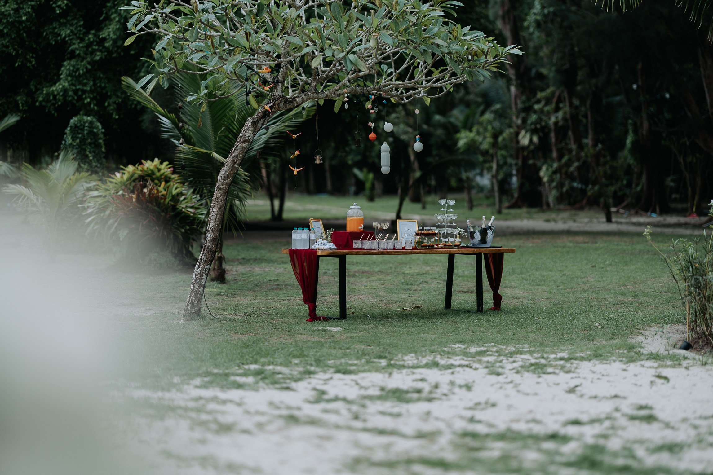 Bride and groom participating in a sacred Buddhist wedding blessing in Thailand