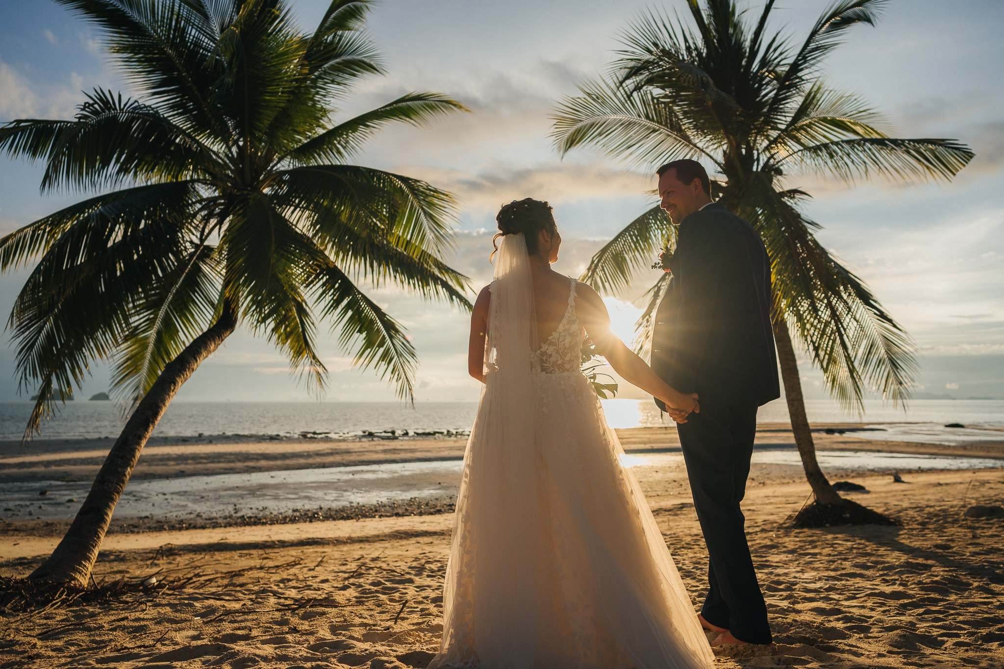 Destination beach wedding in Koh Samui, Thailand with the couple, family members and friends enjoying a tropical wedding ceremony by the sea