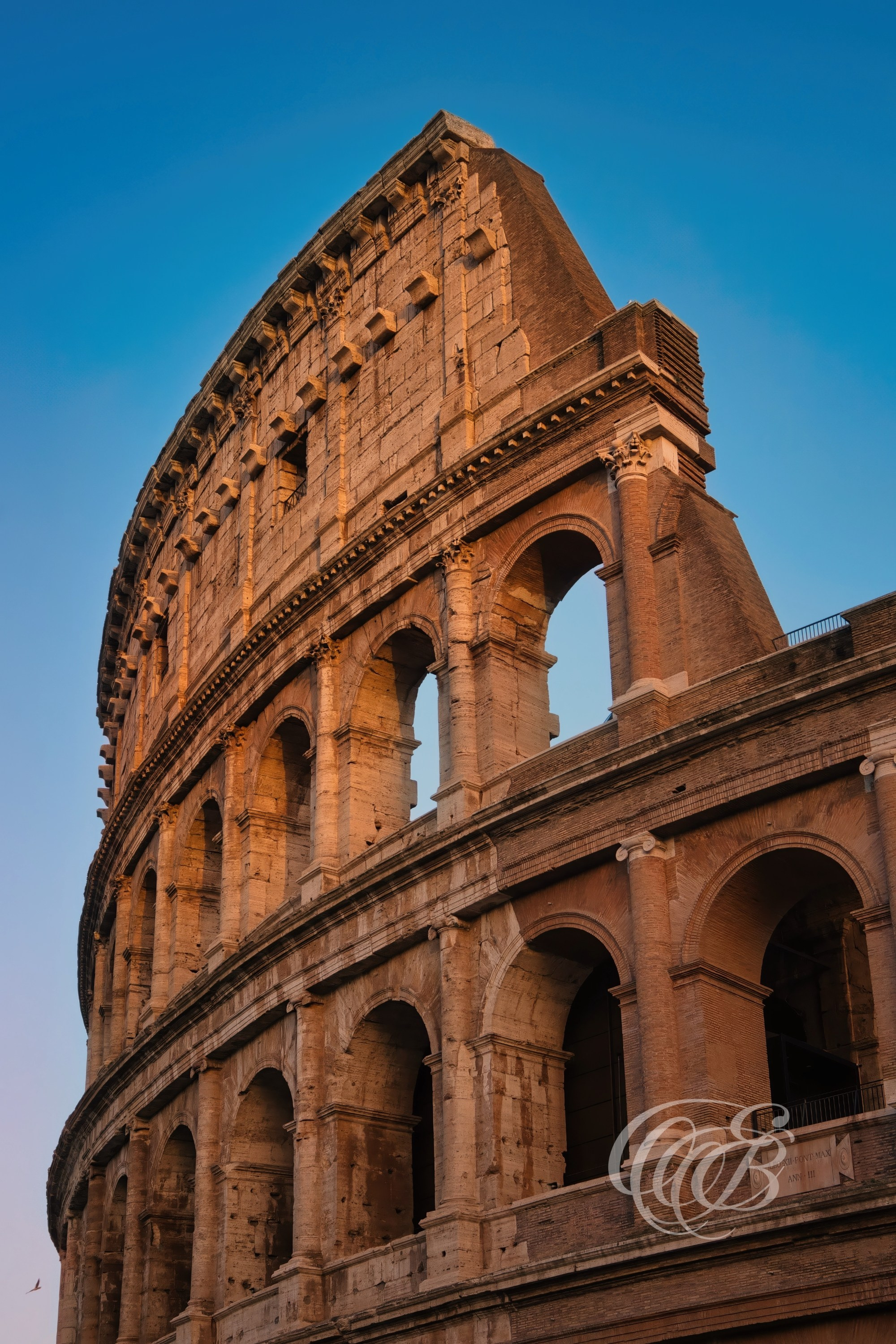 ITALY TRAVEL PHOTOGRAPHY – ITALY – ROME — Late Afternoon at The Colosseum — View of the ancient Roman amphitheater built in the 1st century AD, showing arches, stone structure, and historic architecture in Rome, Italy — Eduardo Bartoli Photography.