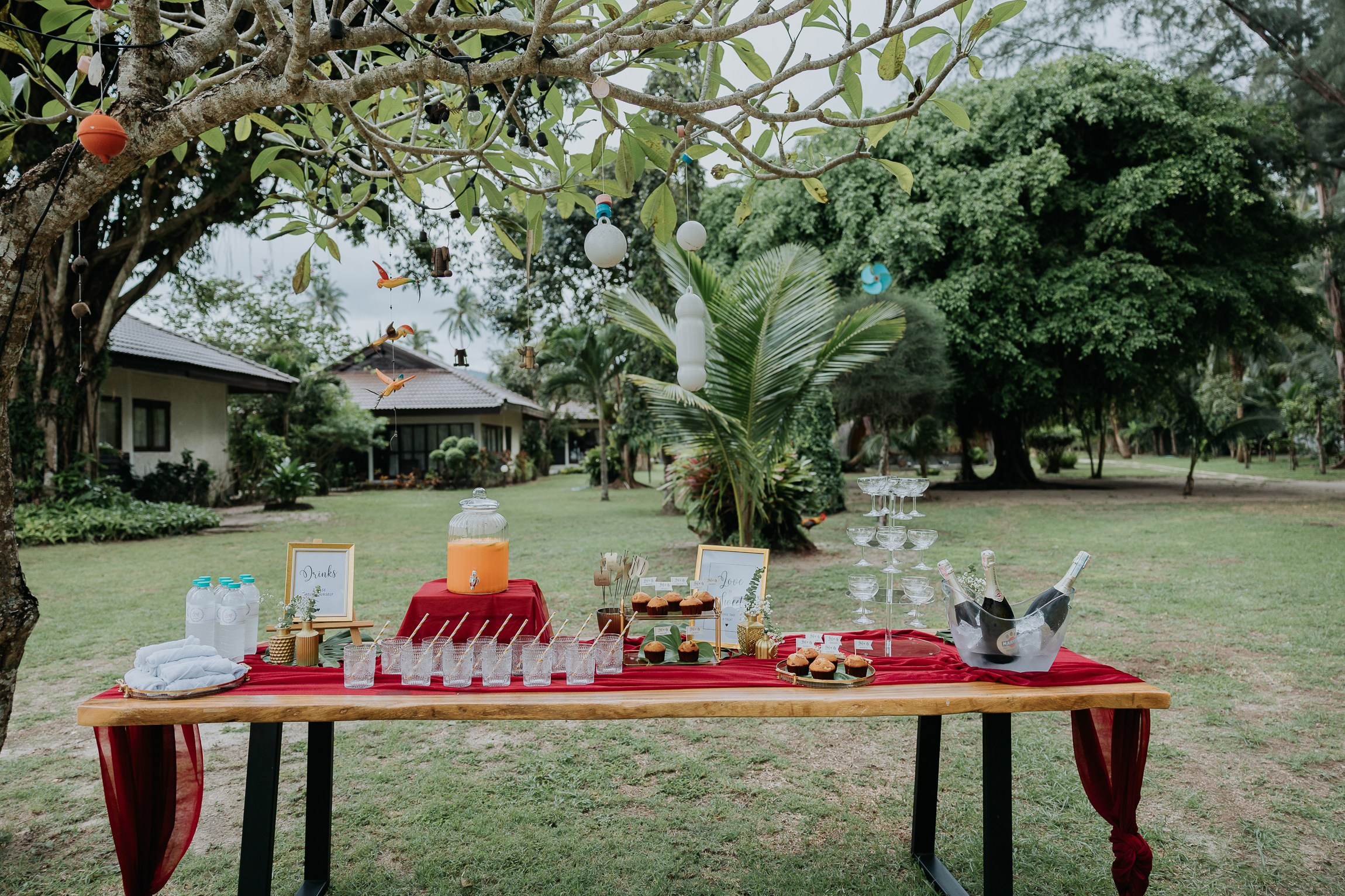Bride and groom participating in a sacred Buddhist wedding blessing in Thailand