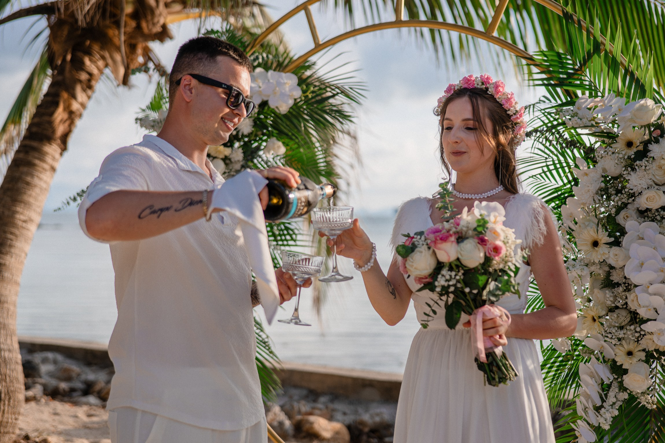 Bride and groom during a romantic beach wedding ceremony on Koh Samui, Thailand, surrounded by tropical scenery and ocean views