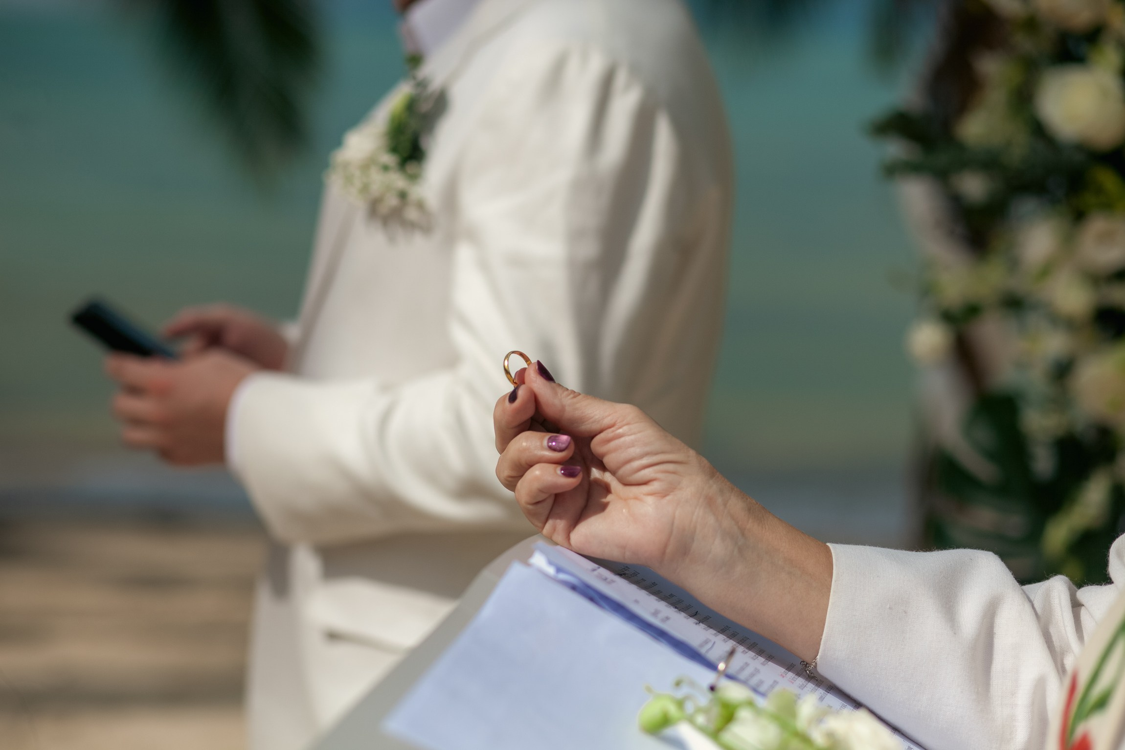 Romantic destination wedding on Koh Samui beach with tropical flowers, ocean views and happy newlyweds