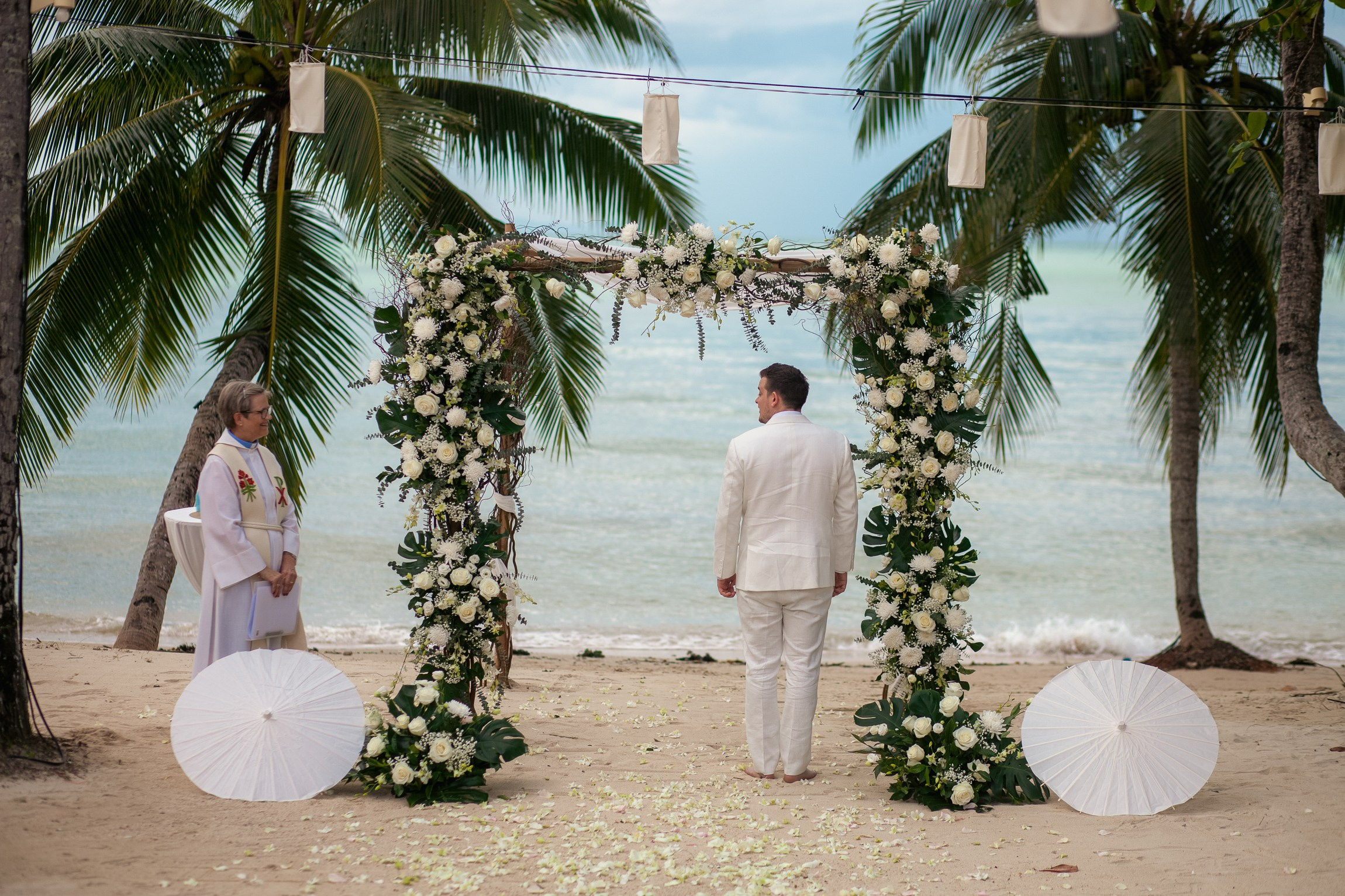 Couple celebrating a private destination wedding for two on a sandy beach in Koh Samui, Thailand