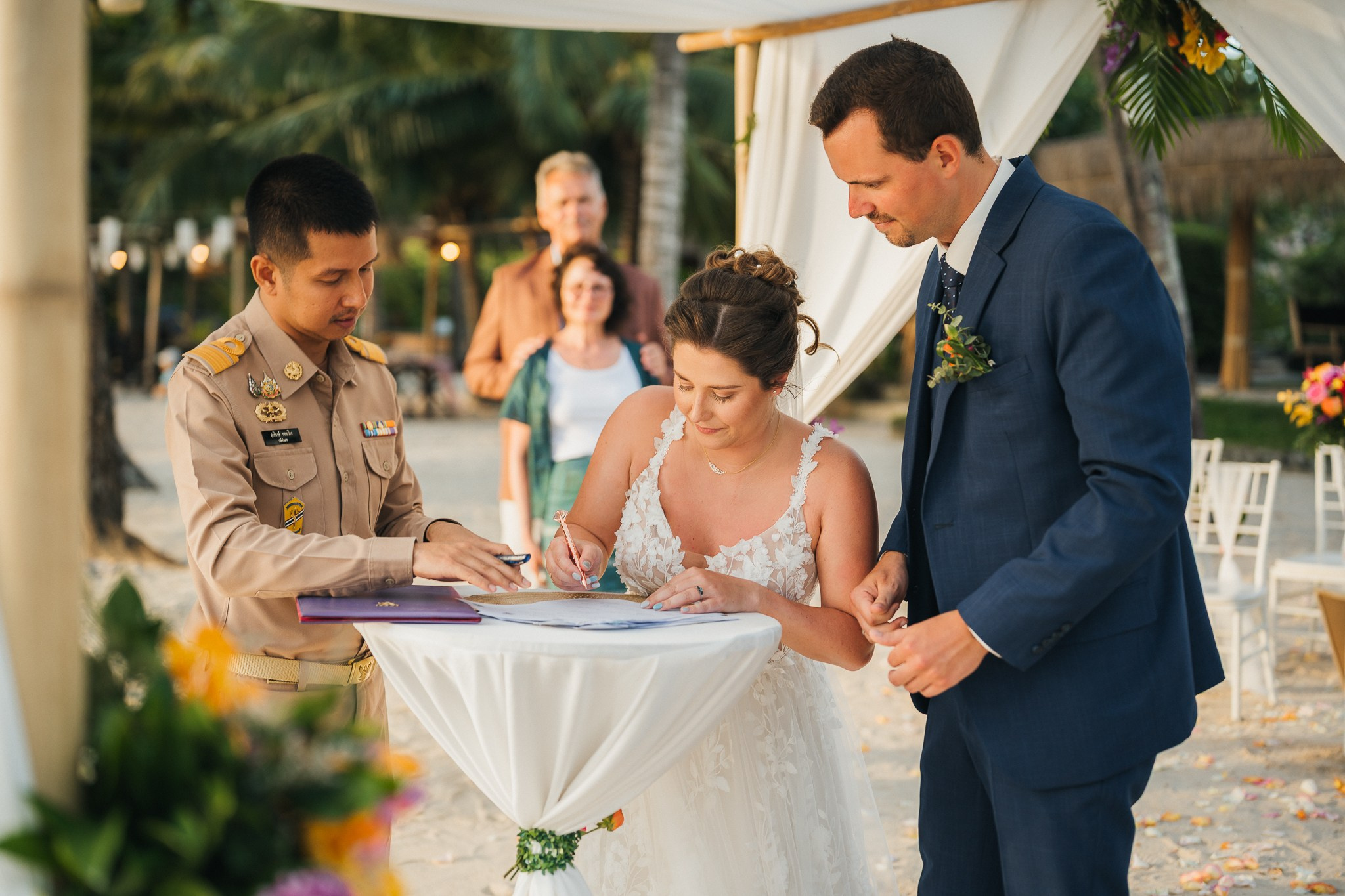 Destination beach wedding in Koh Samui, Thailand with the couple, family members and friends enjoying a tropical wedding ceremony by the sea