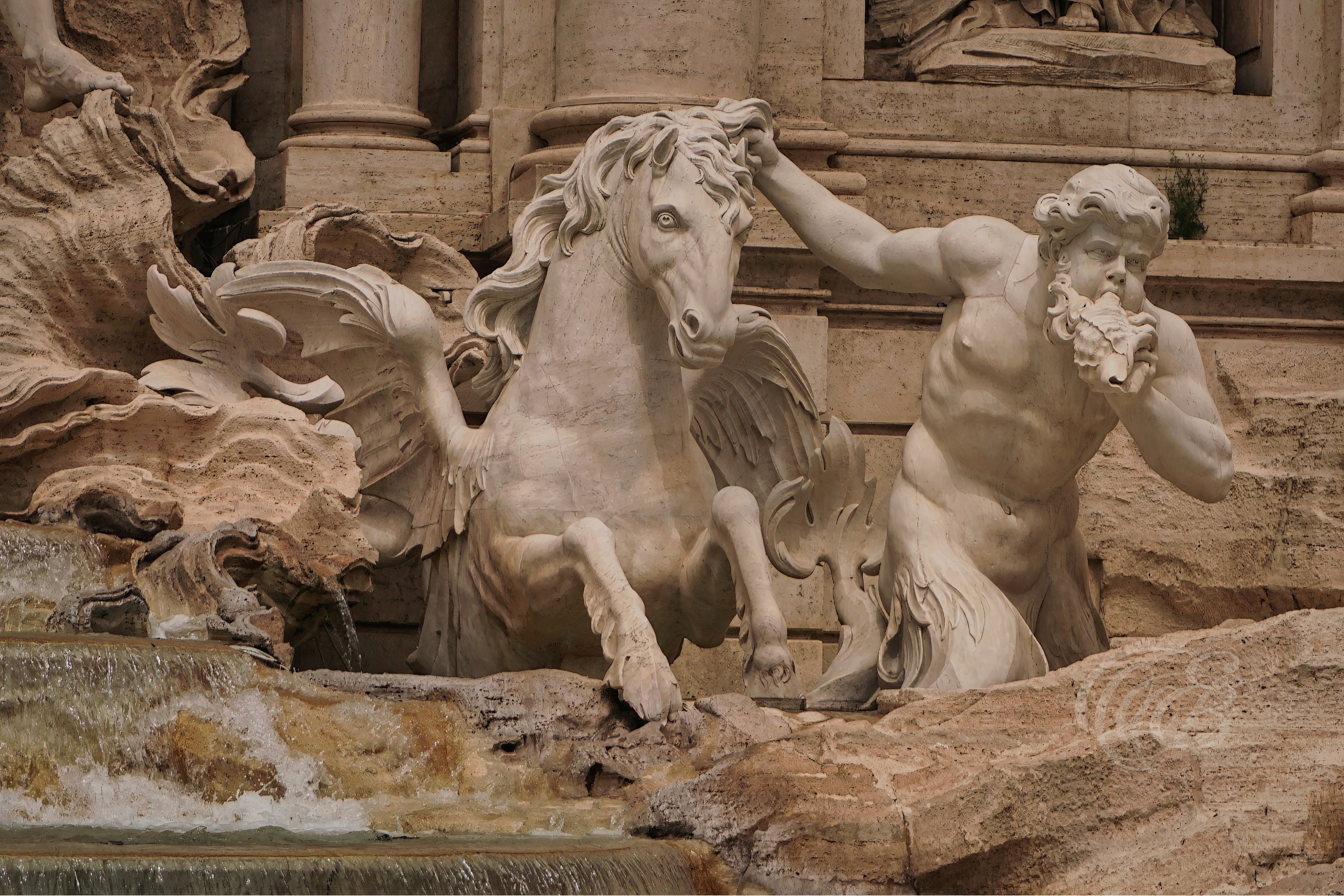 ITALY TRAVEL PHOTOGRAPHY – ITALY – ROME — Trevi Fountain Triton & the Hippocampus — Sculptural detail of the Trevi Fountain showing Triton and mythological hippocampus figures within the Baroque fountain at Palazzo Poli, Rome, Italy — Eduardo Bartoli Photography.