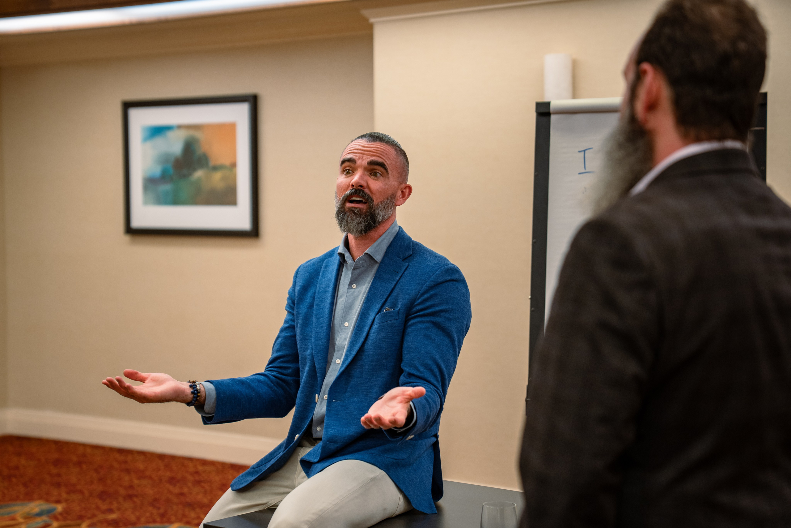 Two attendees in conversation at real estate networking event