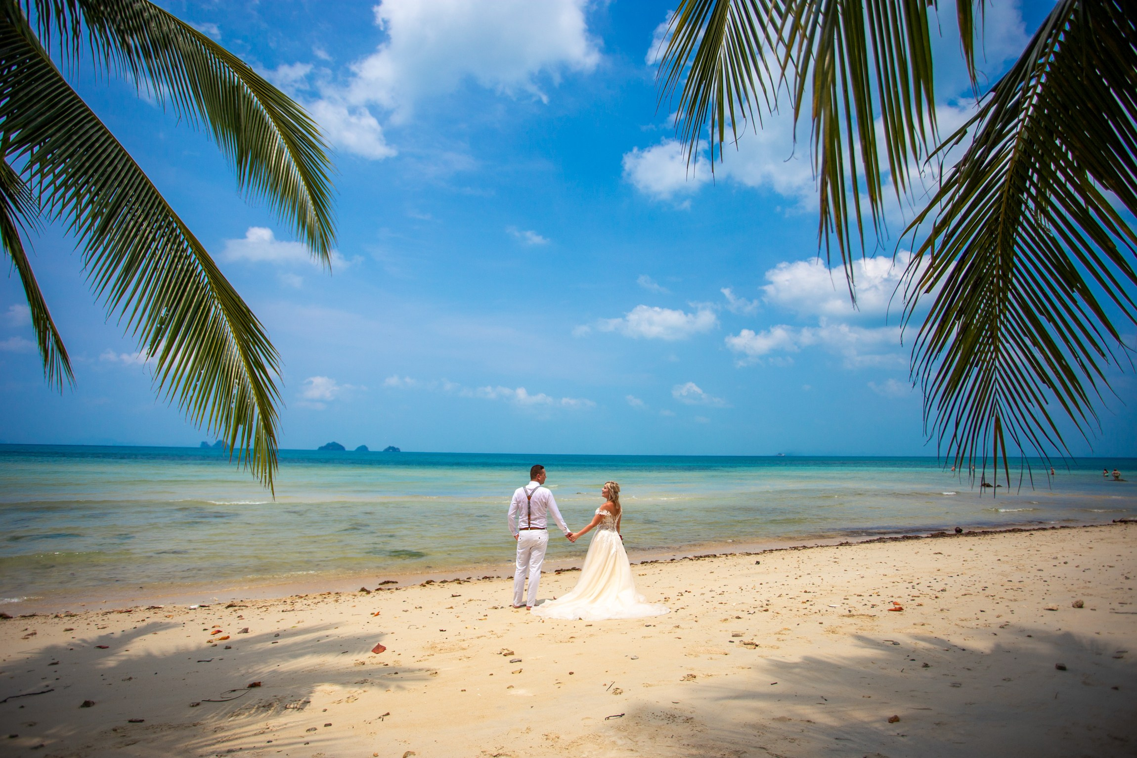Elegant beach wedding setup on Koh Samui, Thailand with bride, groom, flowers and stunning sea backdrop
