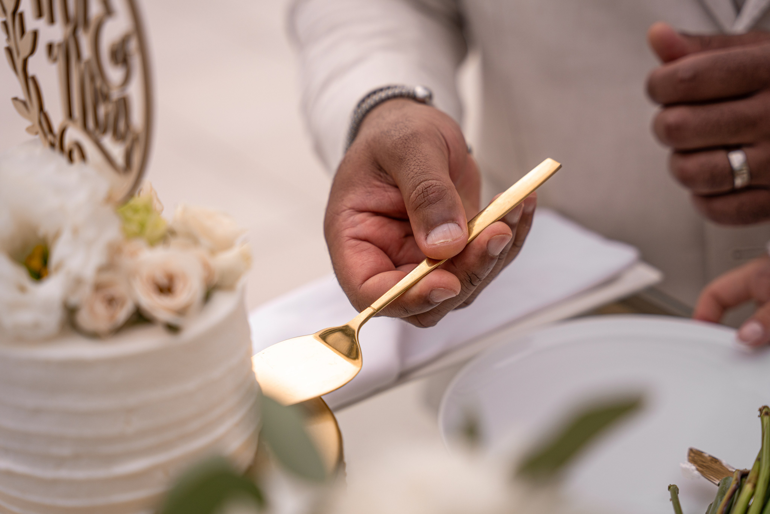 Groom slicing cake at wedding in Riviera Maya, Mexico