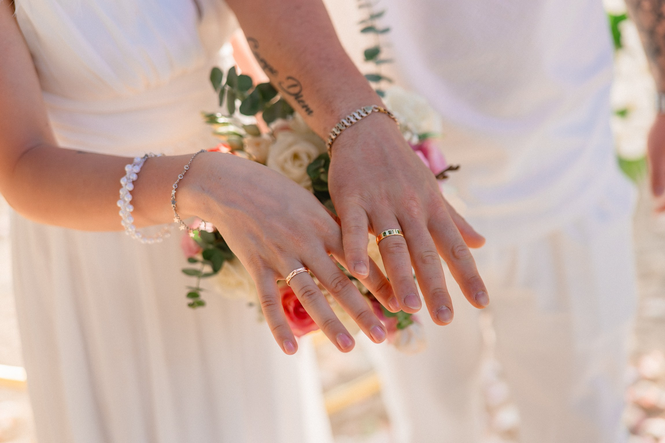 Bride and groom exchanging vows on a private sunset beach