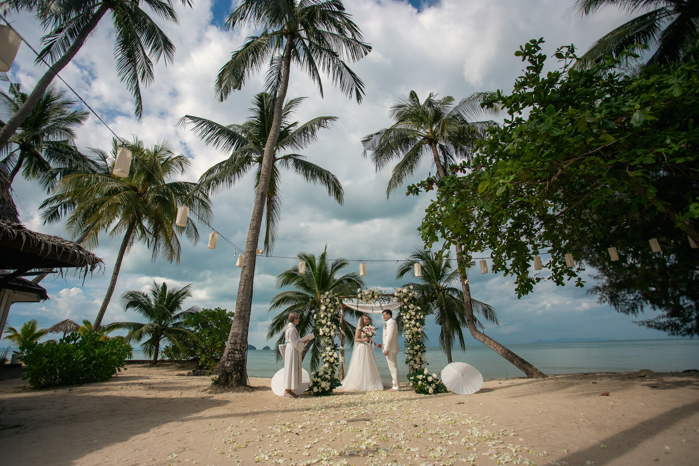 Couple celebrating a private destination wedding for two on a sandy beach in Koh Samui, Thailand