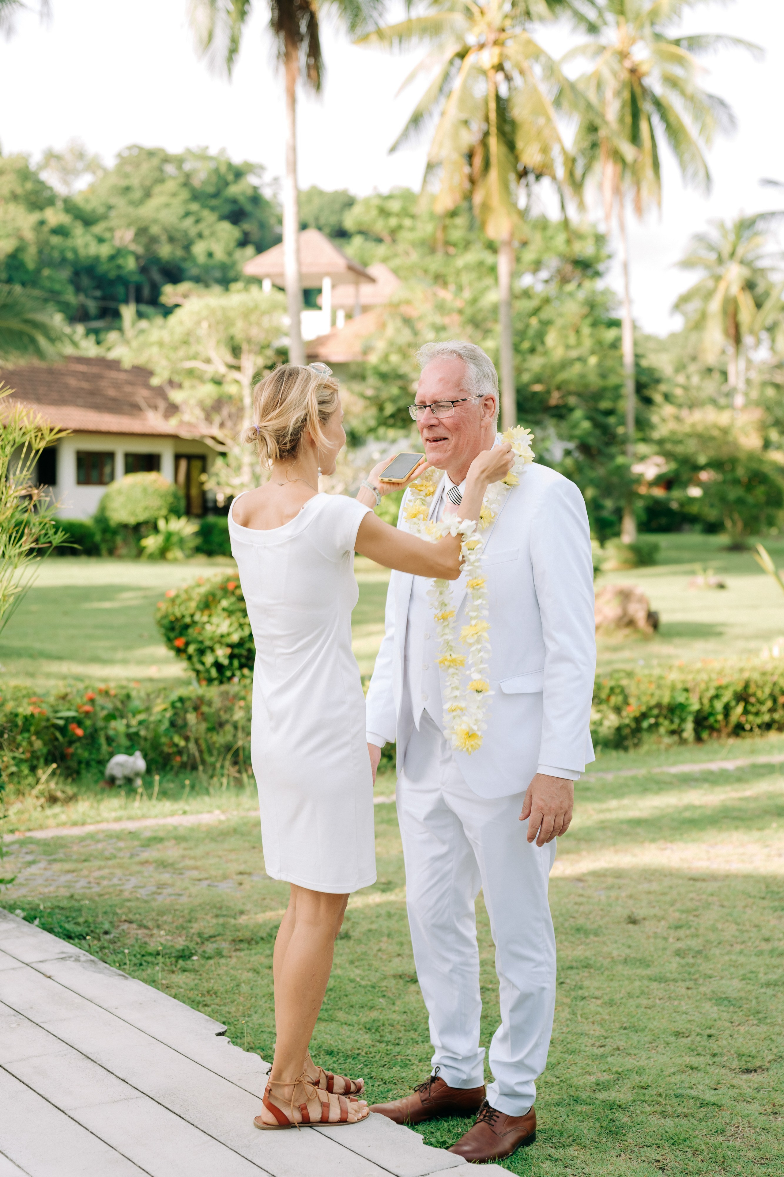 Couple celebrating a spiritual Buddhist wedding ceremony on Koh Samui