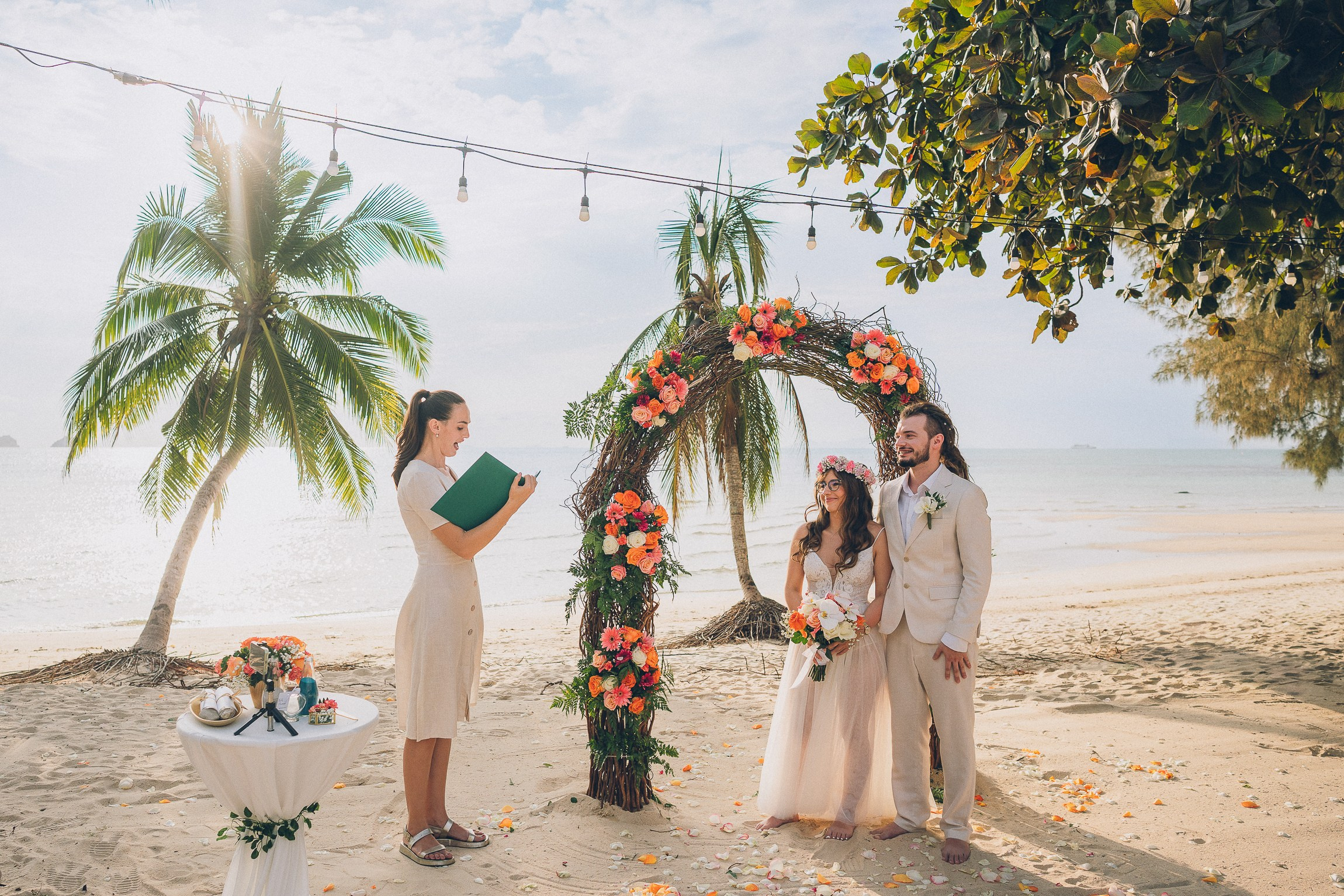 Intimate wedding for two on a tropical beach in Koh Samui, Thailand with a floral wedding setup and sea view