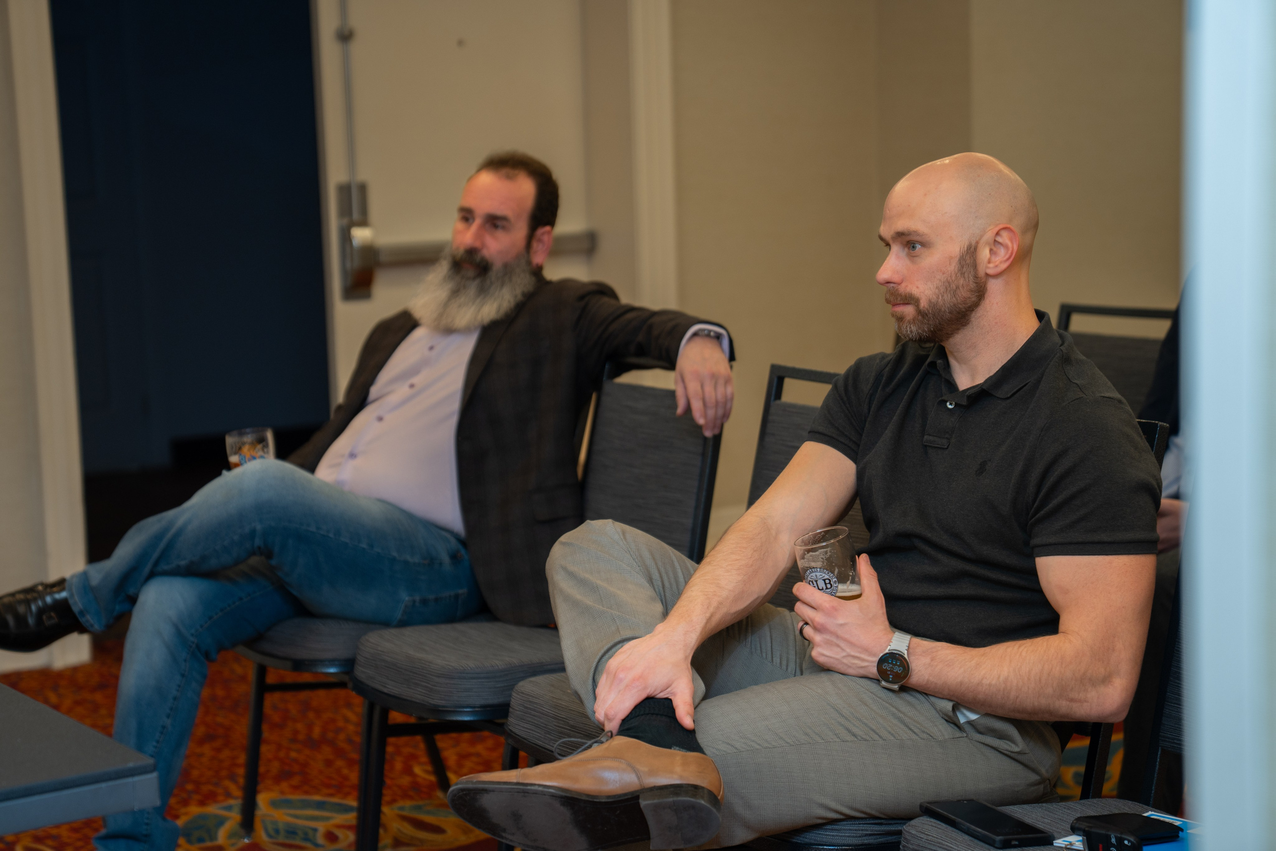 Two attendees seated listening during real estate networking session