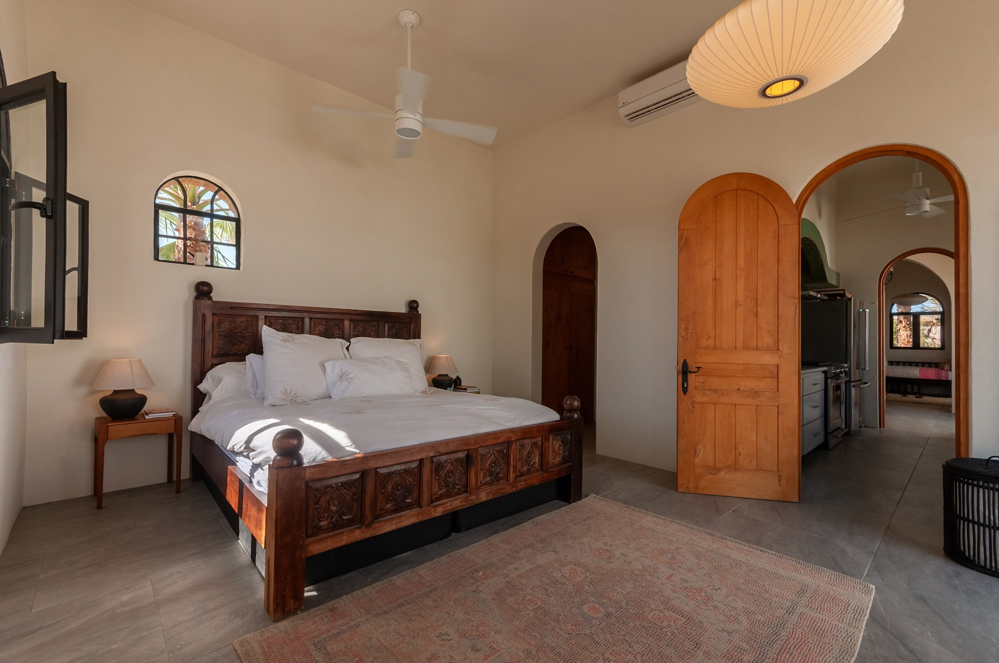 Master bedroom in Todos Santos Baja California Sur, natural light, ceiling fan and warm minimalist interior design