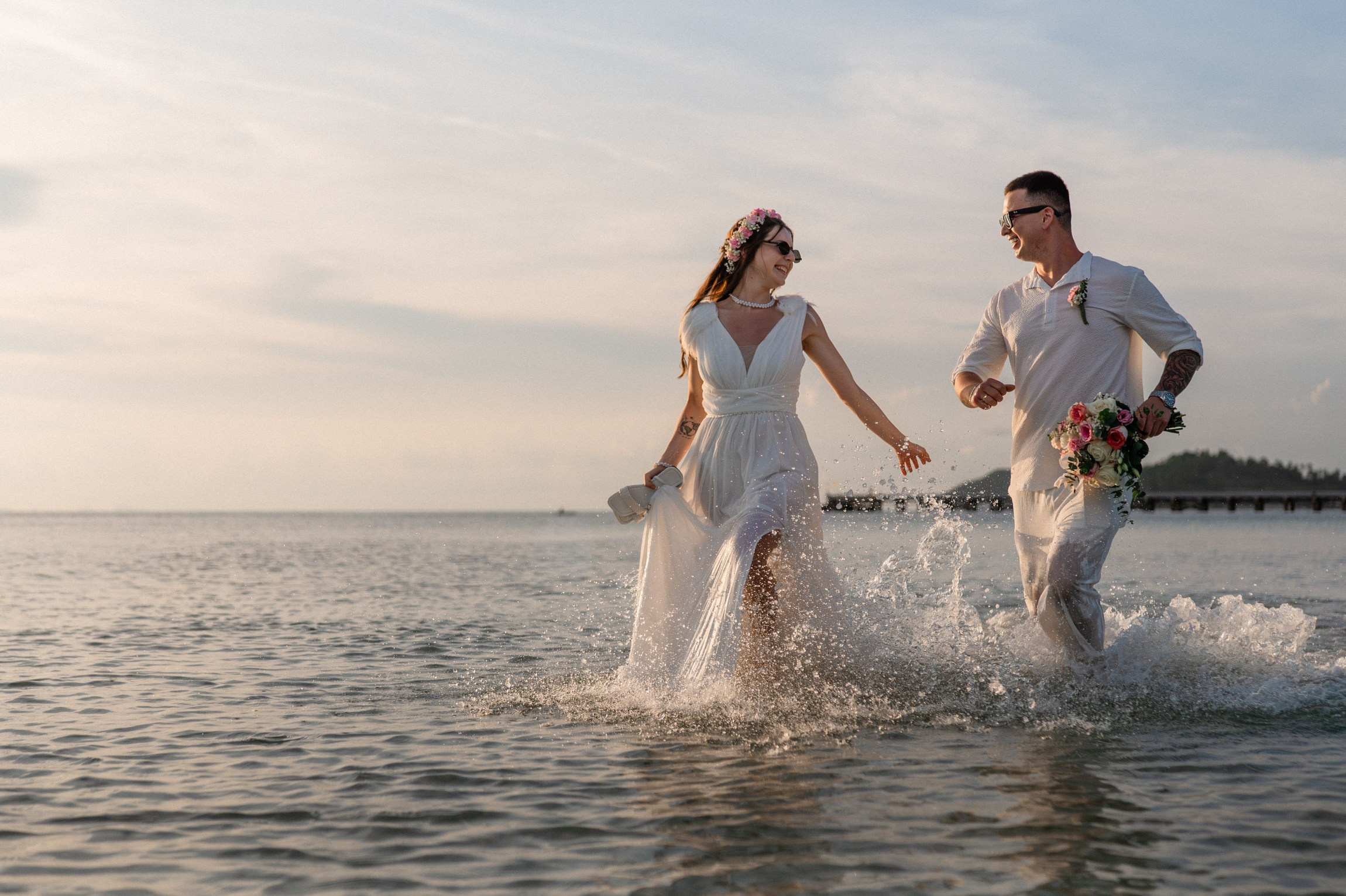 Bride and groom exchanging vows on a private sunset beach