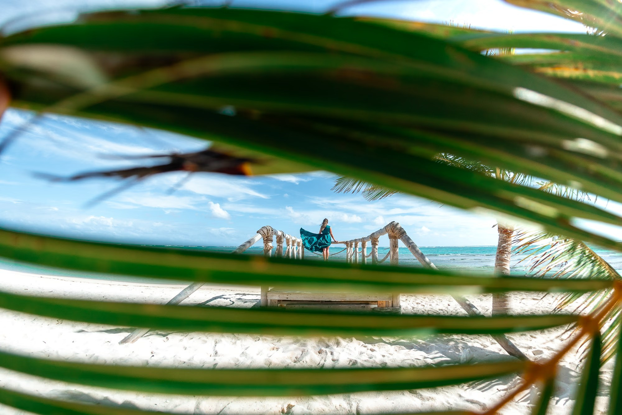 Professional photographer Punta Cana capturing a female sunrise photoshoot on a tropical beach.