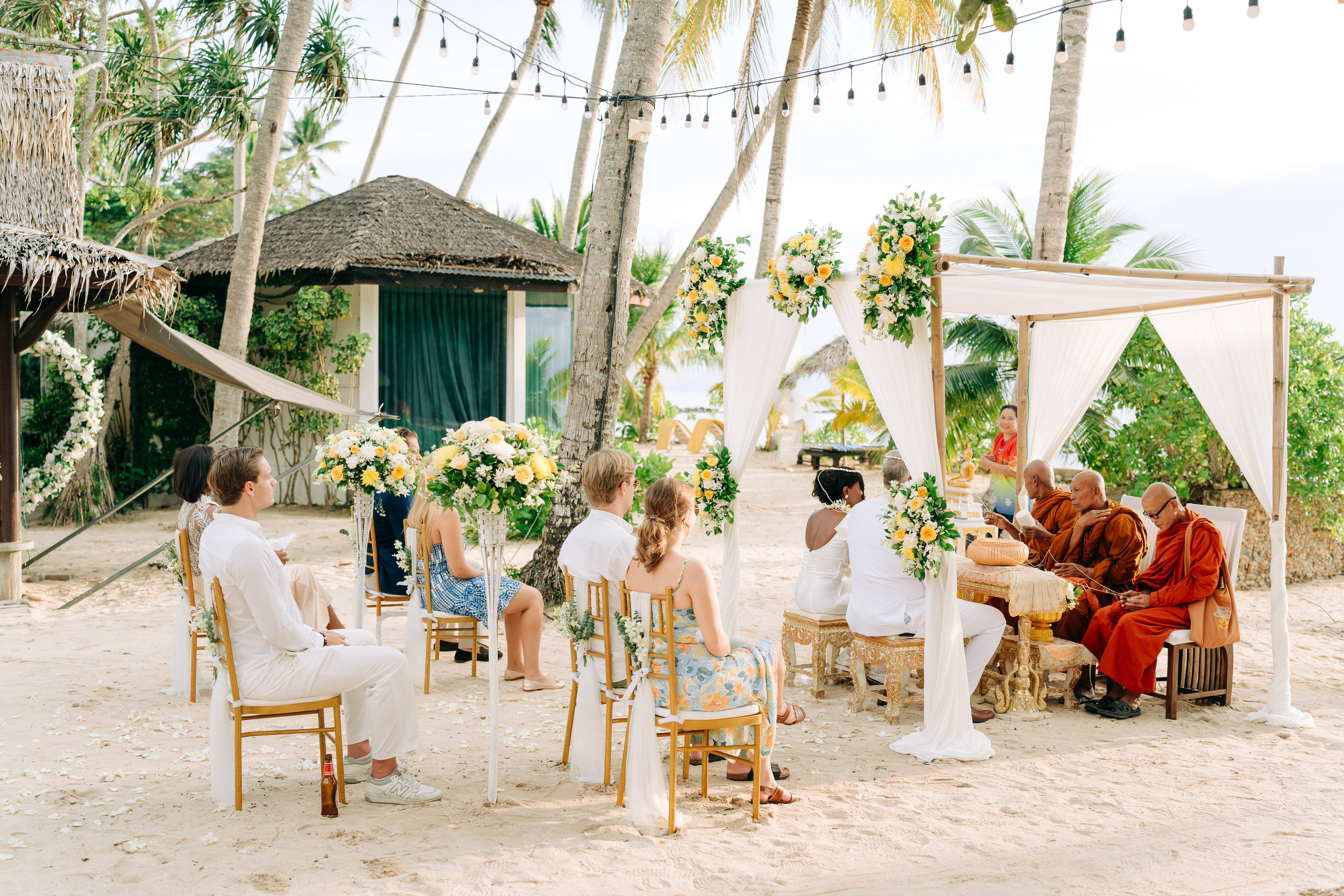 Romantic Buddhist wedding ceremony with guests in Koh Samui, Thailand