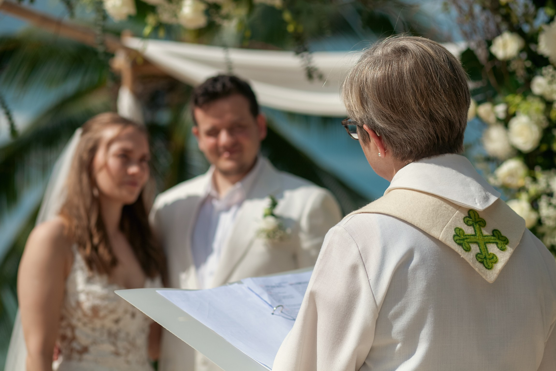Romantic destination wedding on Koh Samui beach with tropical flowers, ocean views and happy newlyweds