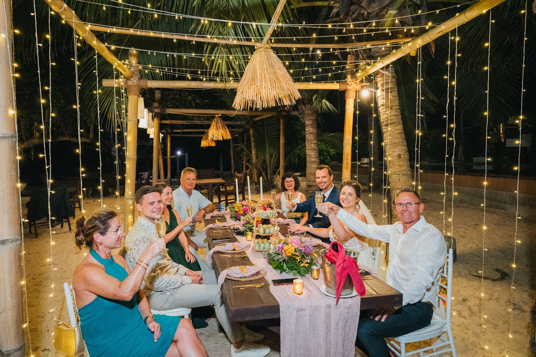 Destination beach wedding in Koh Samui, Thailand with the couple, family members and friends enjoying a tropical wedding ceremony by the sea