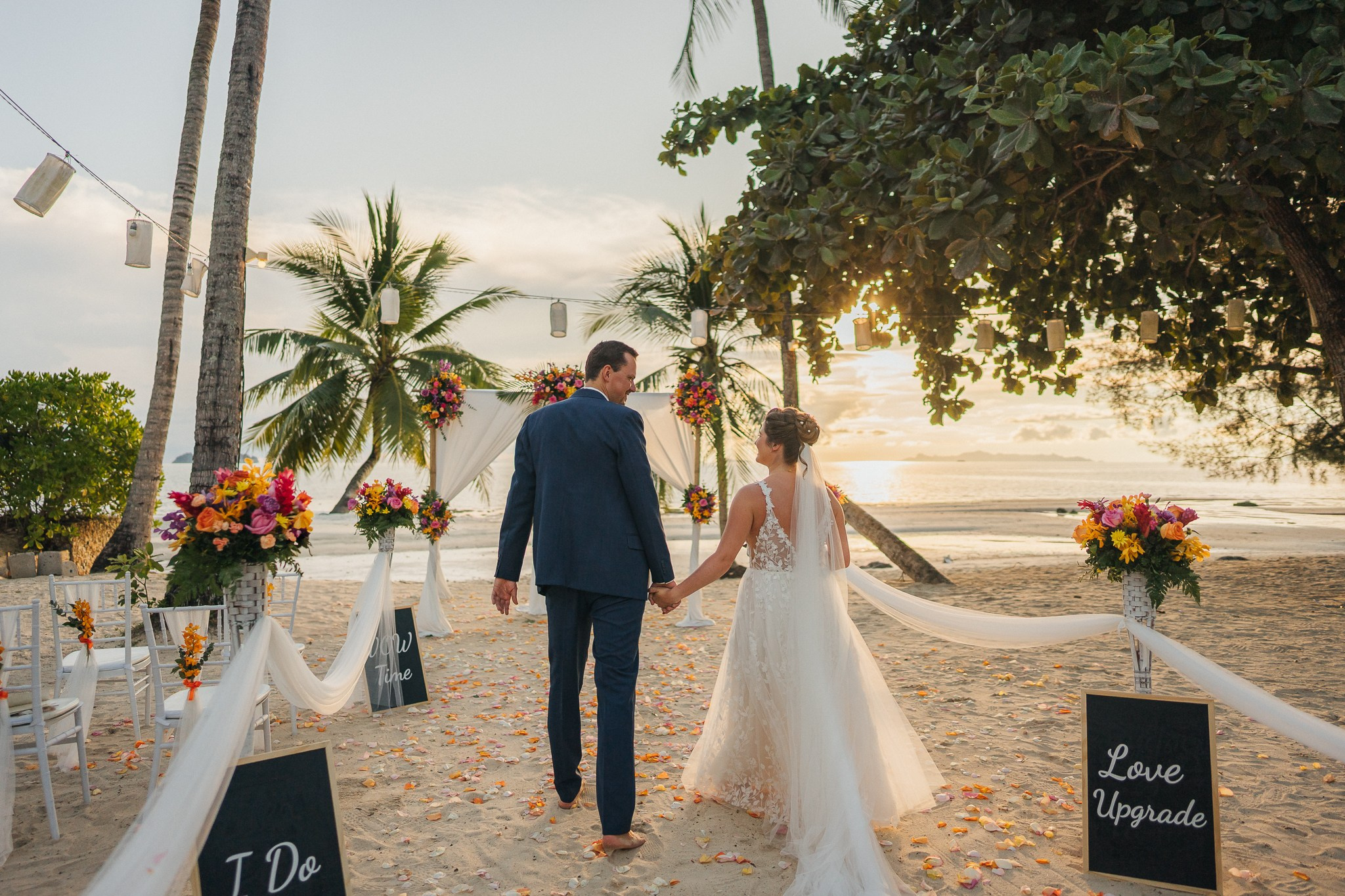 Destination beach wedding in Koh Samui, Thailand with the couple, family members and friends enjoying a tropical wedding ceremony by the sea