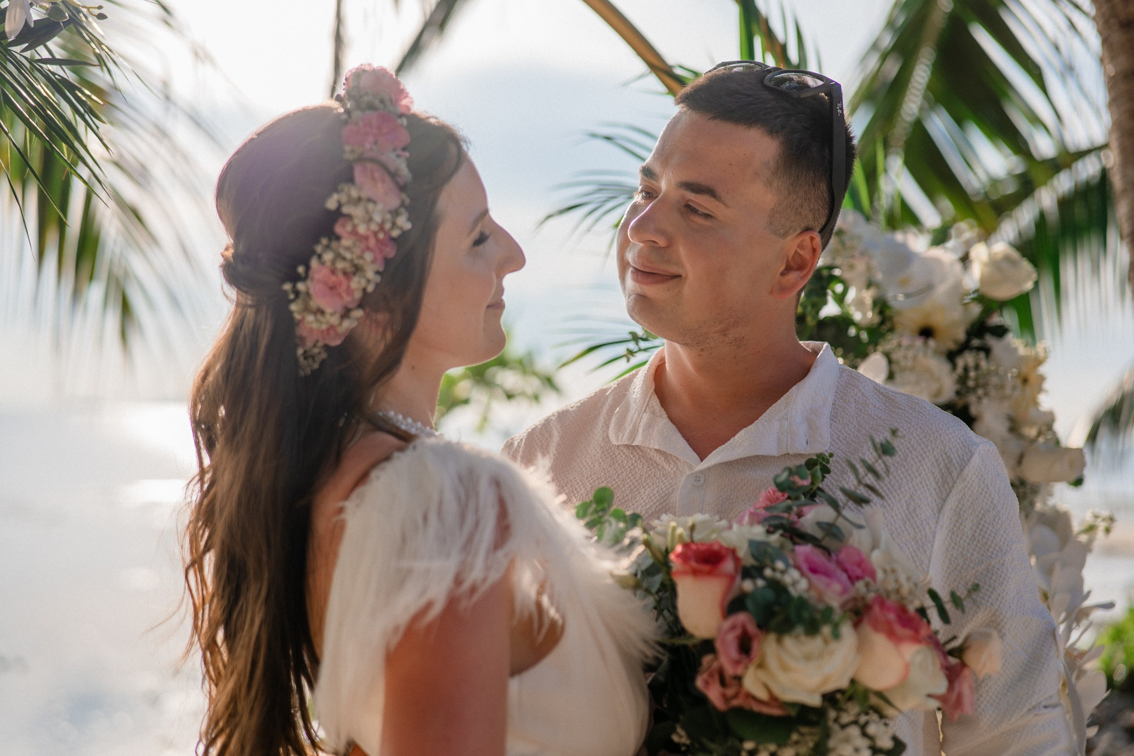 Bride and groom exchanging vows on a private sunset beach