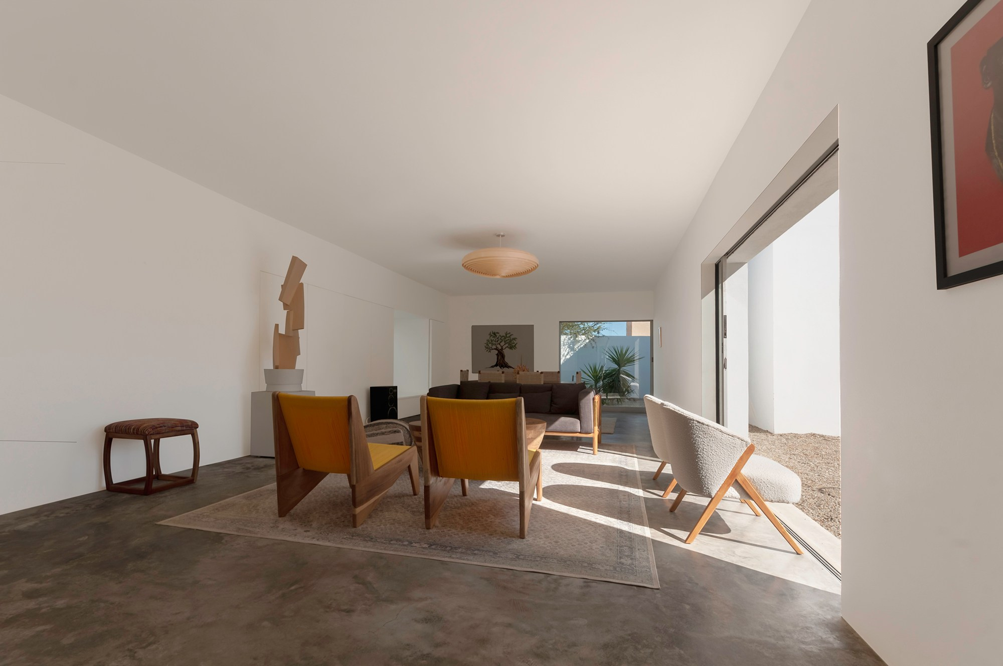 Modern minimalist living room in Los Cabos . bright white interior with sliding glass doors and natural sunlight, high end property photography