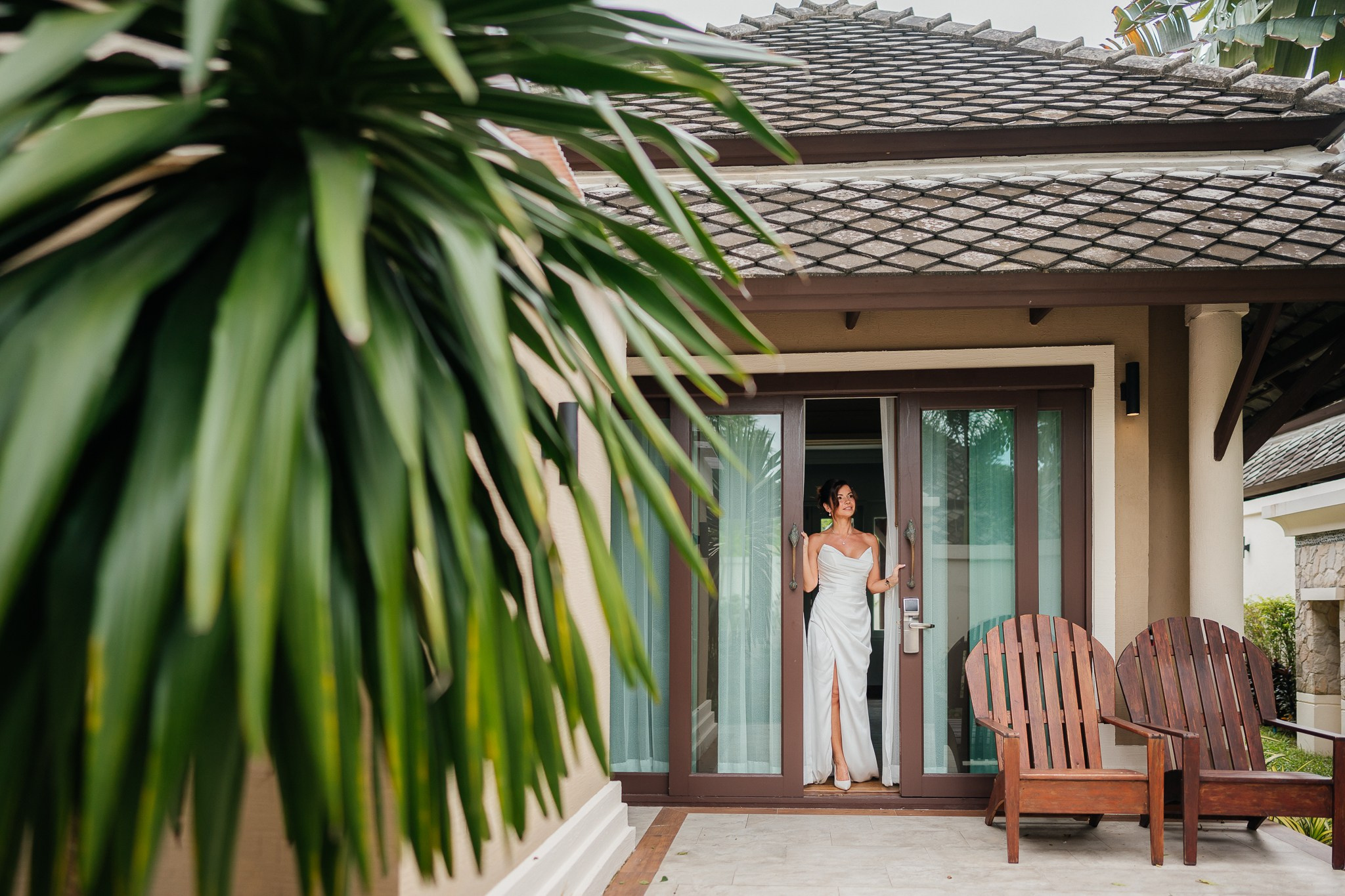 Bride and groom celebrating a beach wedding with their children in Koh Samui, Thailand, surrounded by tropical scenery and ocean views