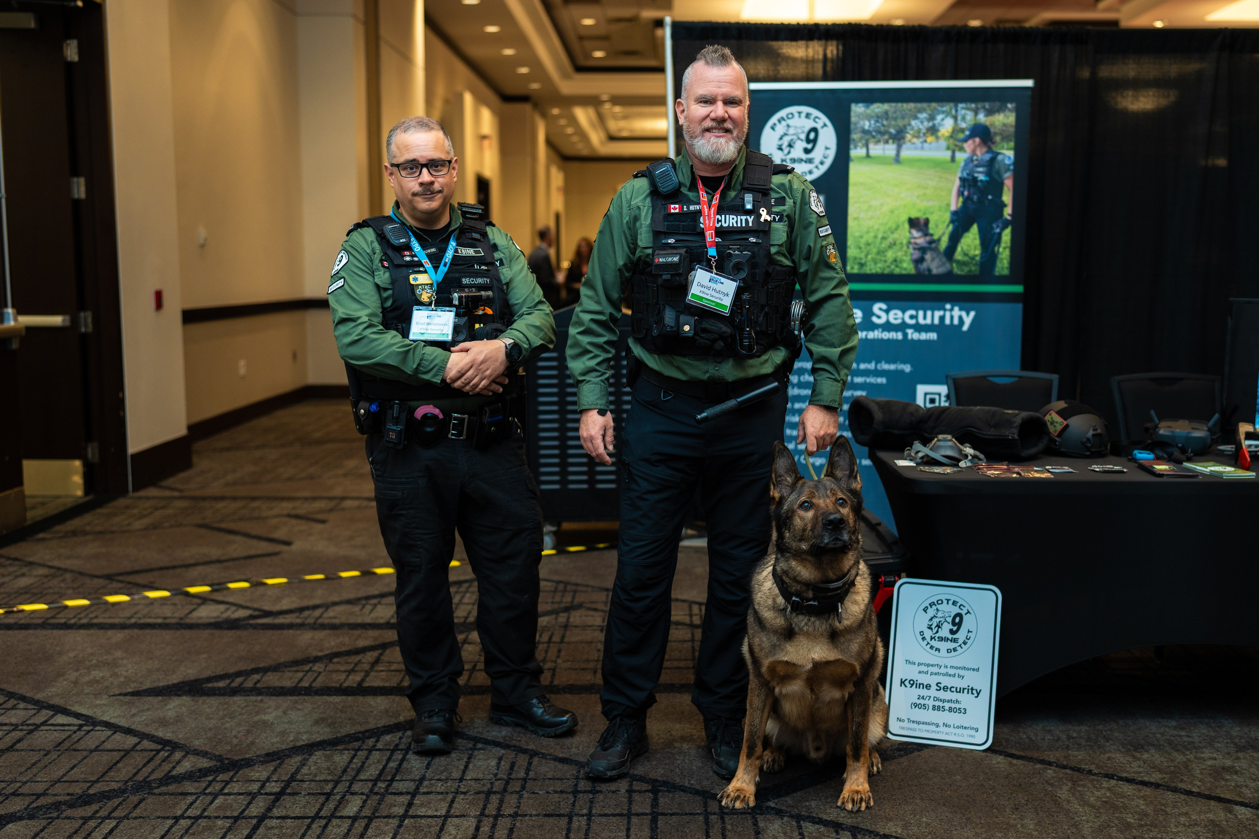 Group of officers and staff posing at booth, Blueline Expo 2026