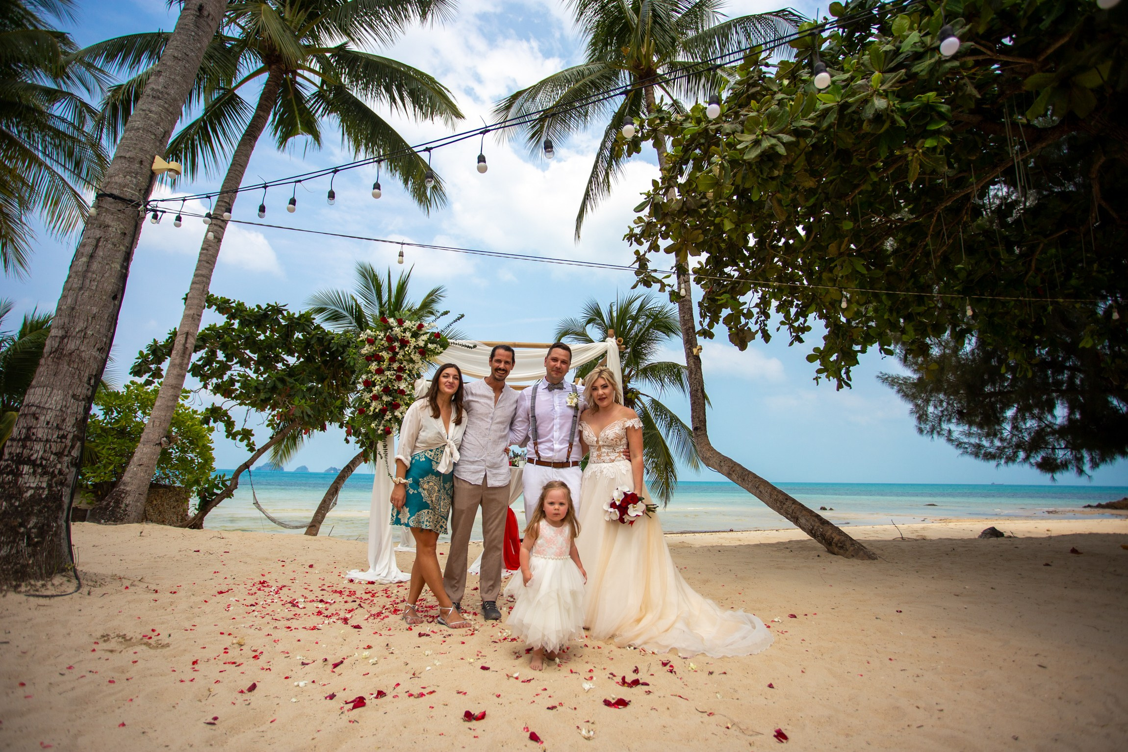 Bride and groom during a romantic beach wedding ceremony on Koh Samui, Thailand, surrounded by tropical scenery and ocean views