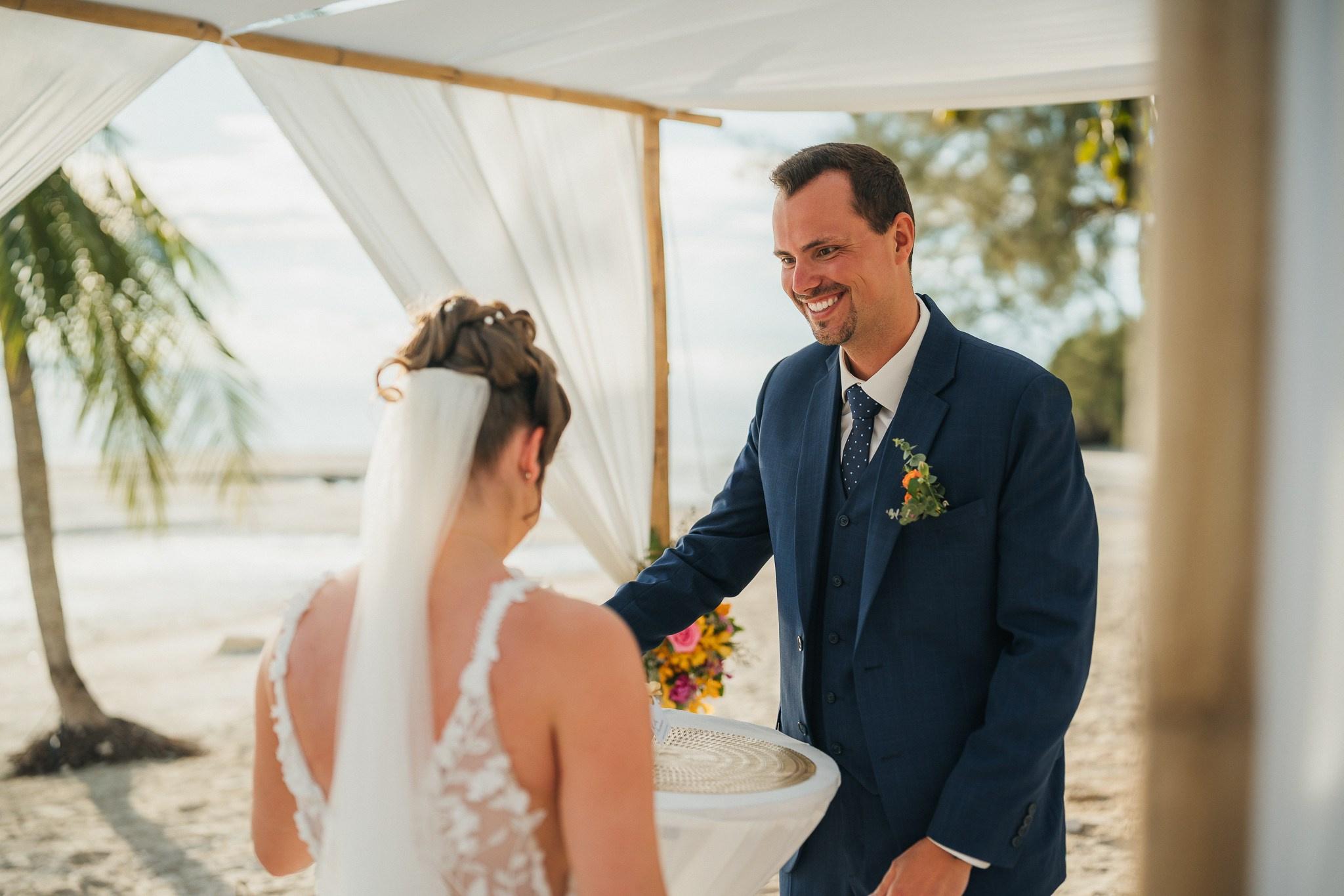 Destination beach wedding in Koh Samui, Thailand with the couple, family members and friends enjoying a tropical wedding ceremony by the sea