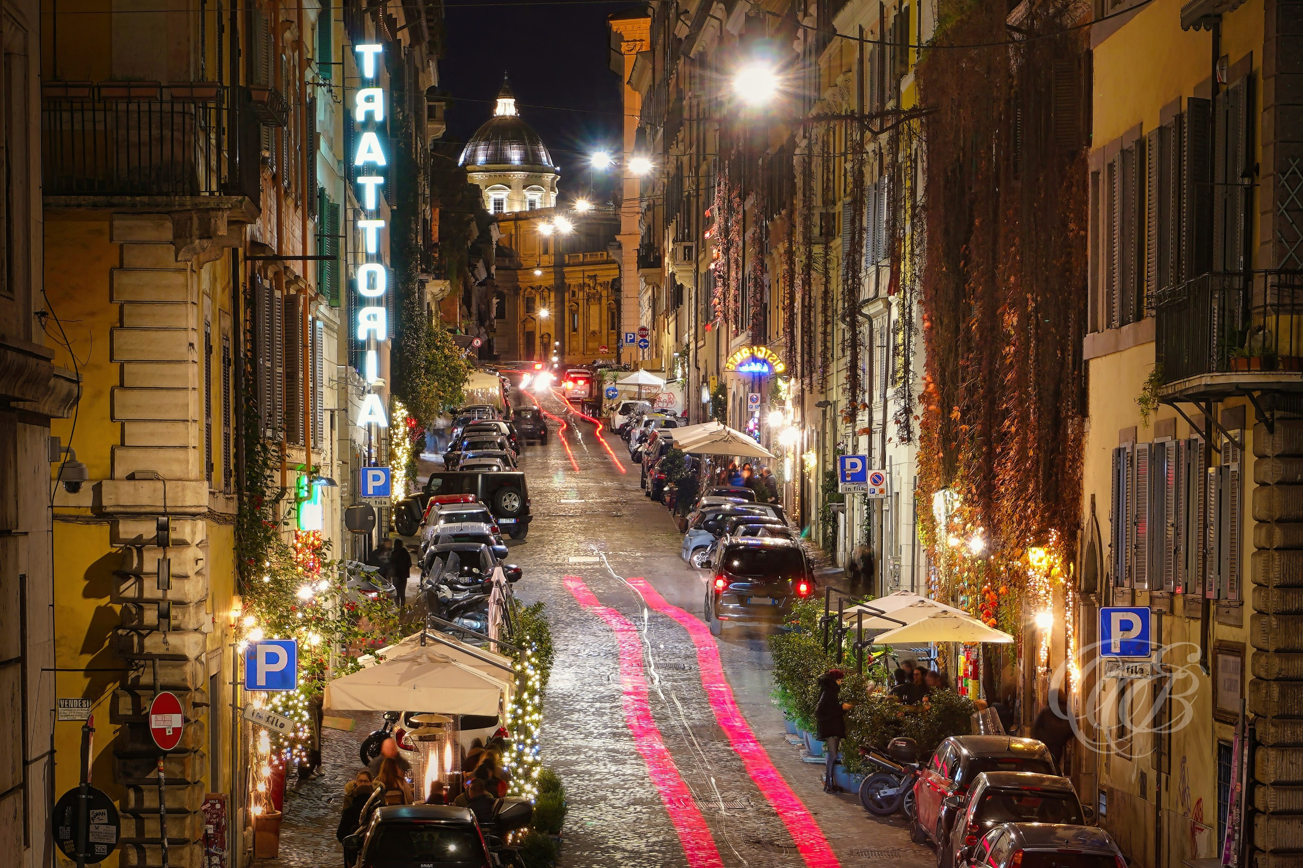 ITALY TRAVEL PHOTOGRAPHY – ITALY – ROME — Via dei Serpenti Nightlife Restaurants — Evening street scene in the Monti district showing restaurants and nightlife along Via dei Serpenti, with Santa Maria Maggiore visible at the end of the street, Rome, Italy — Eduardo Bartoli Photography.