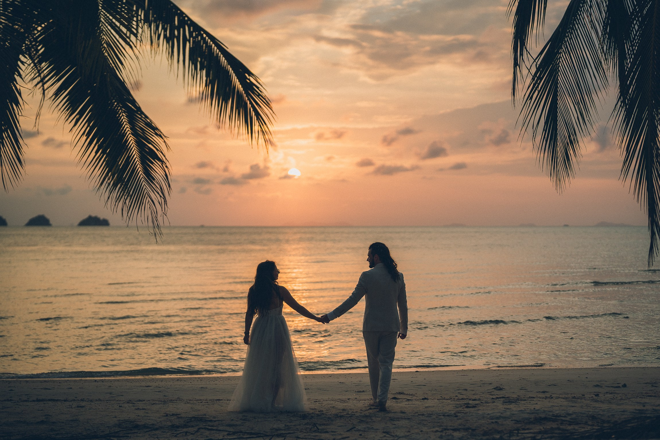 Bride and groom enjoying a just for 2 beach wedding in Koh Samui, Thailand, surrounded by tropical scenery and ocean views