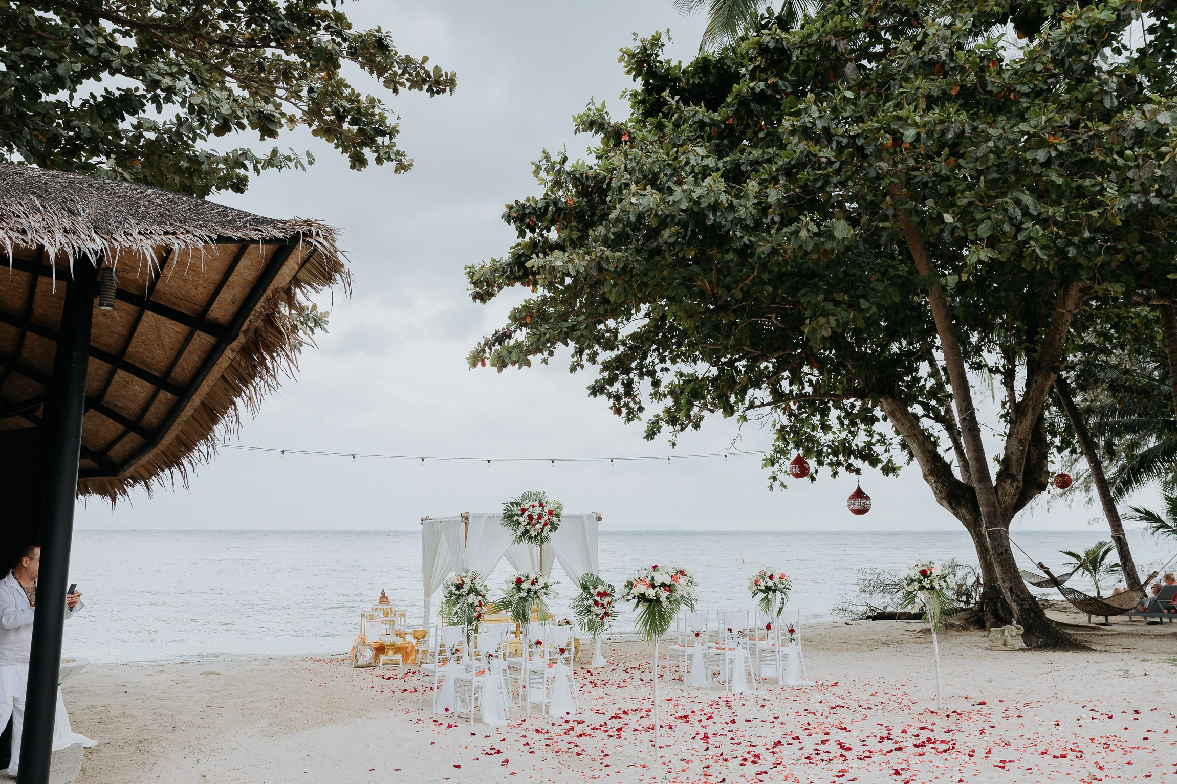 Couple with guests celebrating a spiritual Buddhist wedding ceremony on Koh Samui