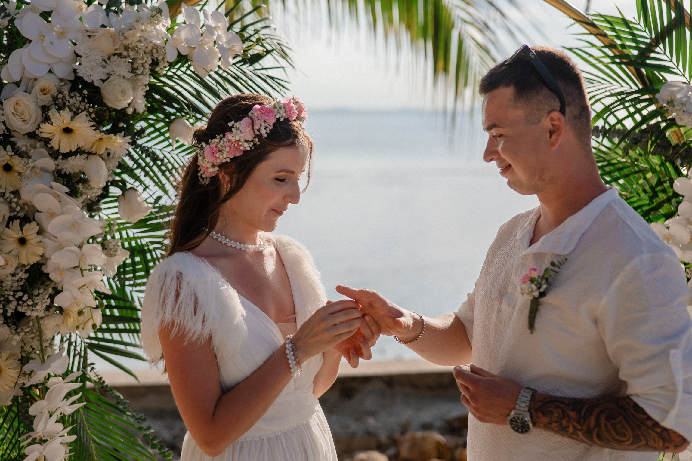Bride and groom during a romantic beach wedding ceremony on Koh Samui, Thailand, surrounded by tropical scenery and ocean views