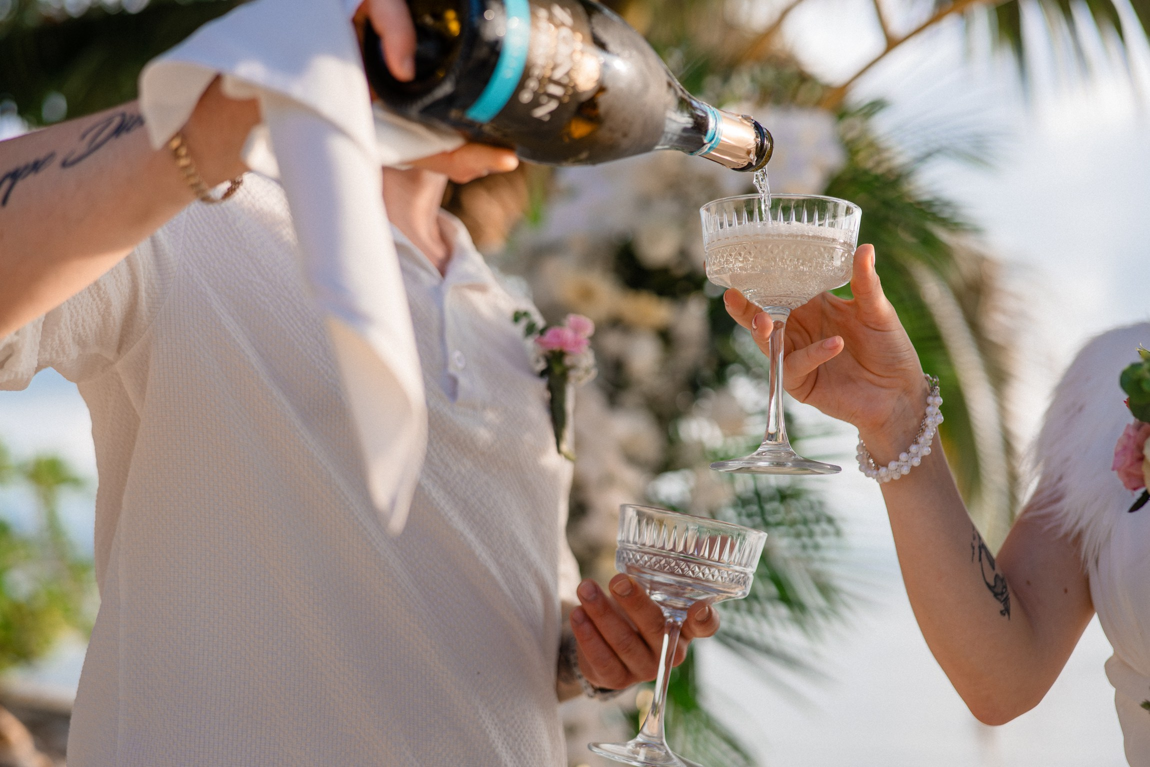 Bride and groom exchanging vows on a private sunset beach