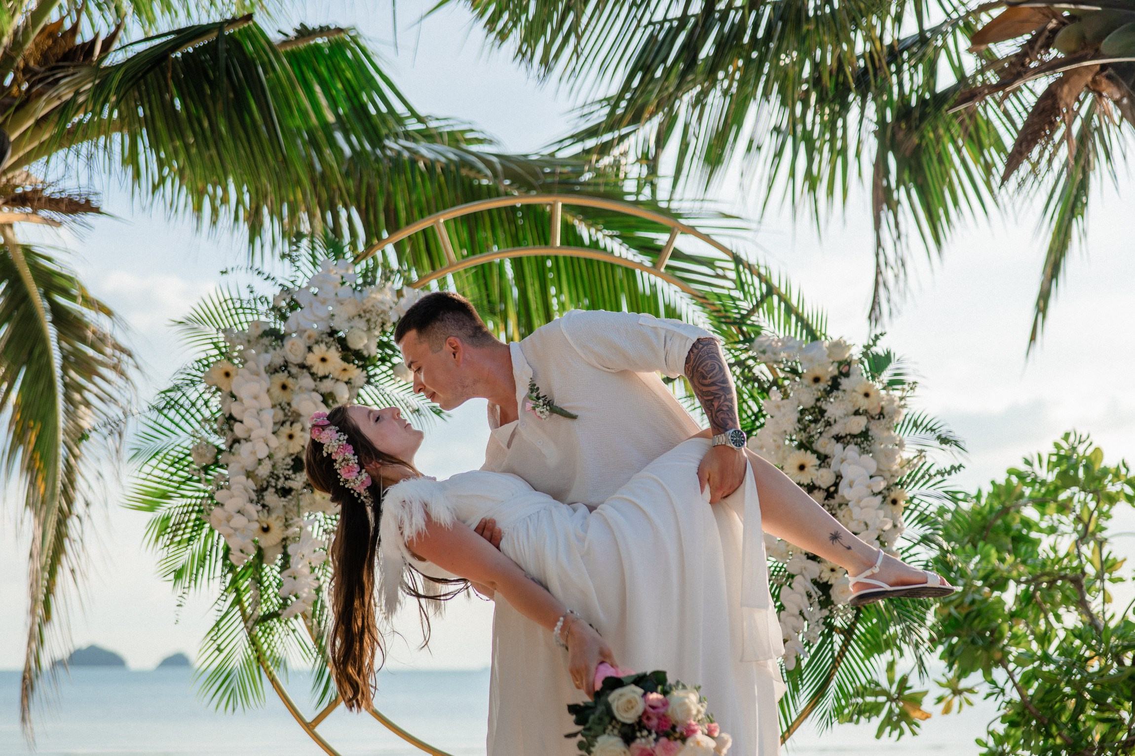 Bride and groom during a romantic beach wedding ceremony on Koh Samui, Thailand, surrounded by tropical scenery and ocean views