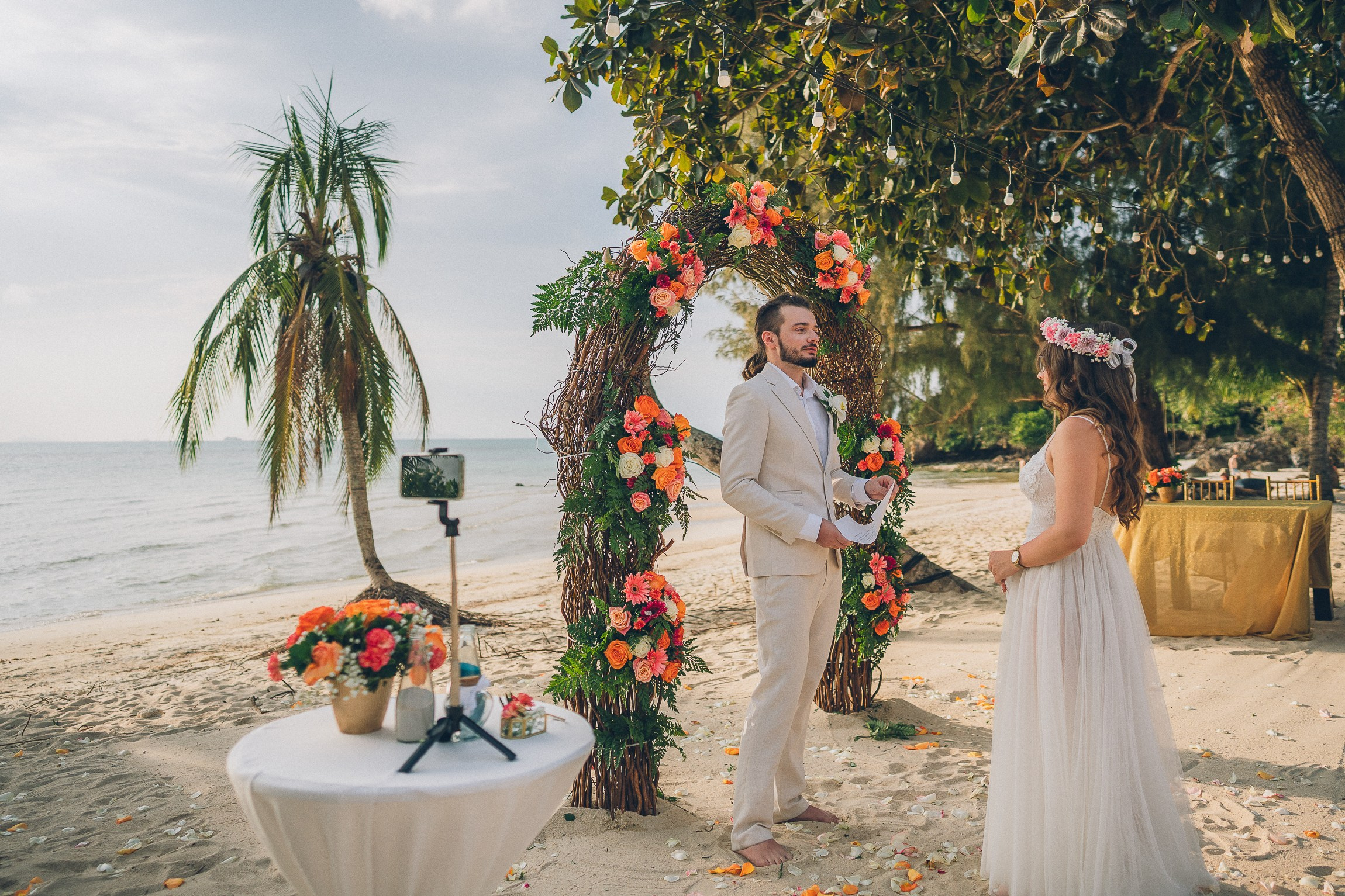 Intimate wedding for two on a tropical beach in Koh Samui, Thailand with a floral wedding setup and sea view