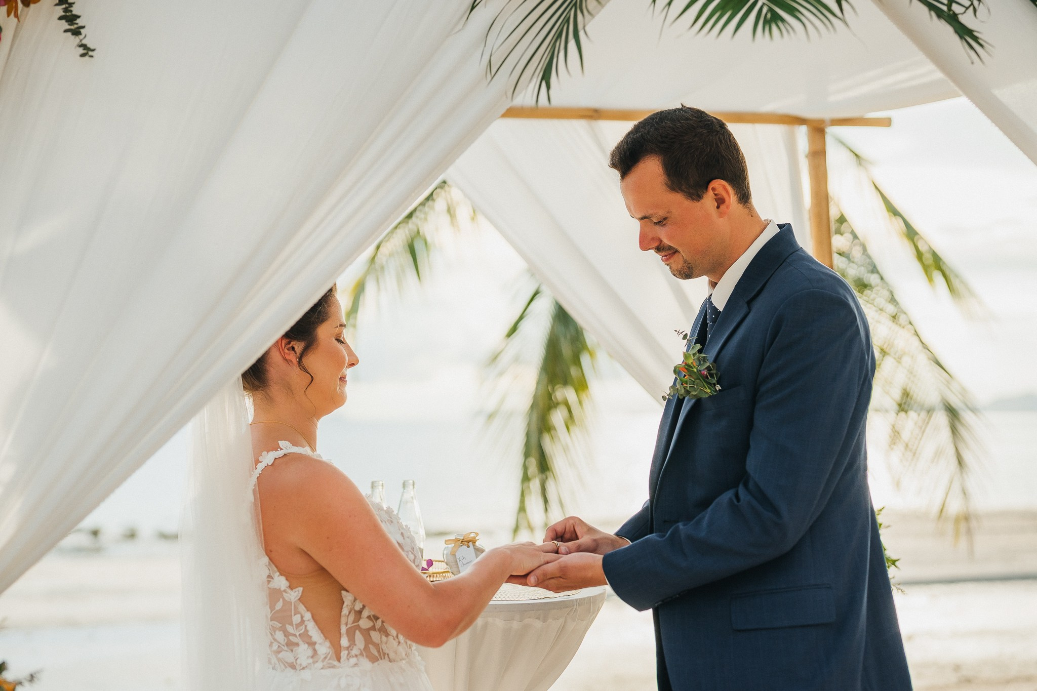 Destination beach wedding in Koh Samui, Thailand with the couple, family members and friends enjoying a tropical wedding ceremony by the sea