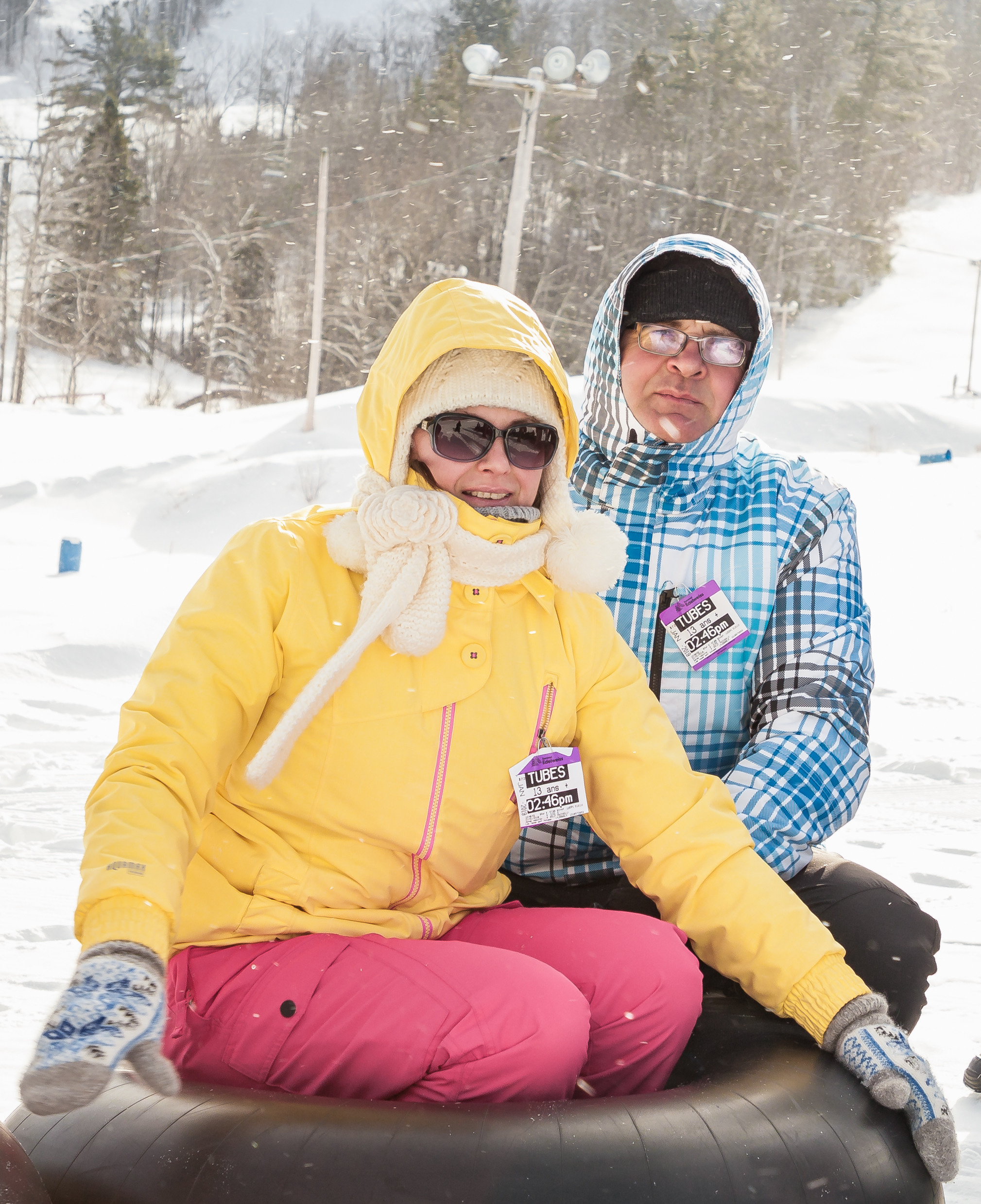 Joyful winter family session with snow-tubing activities in Eastern Ontario.