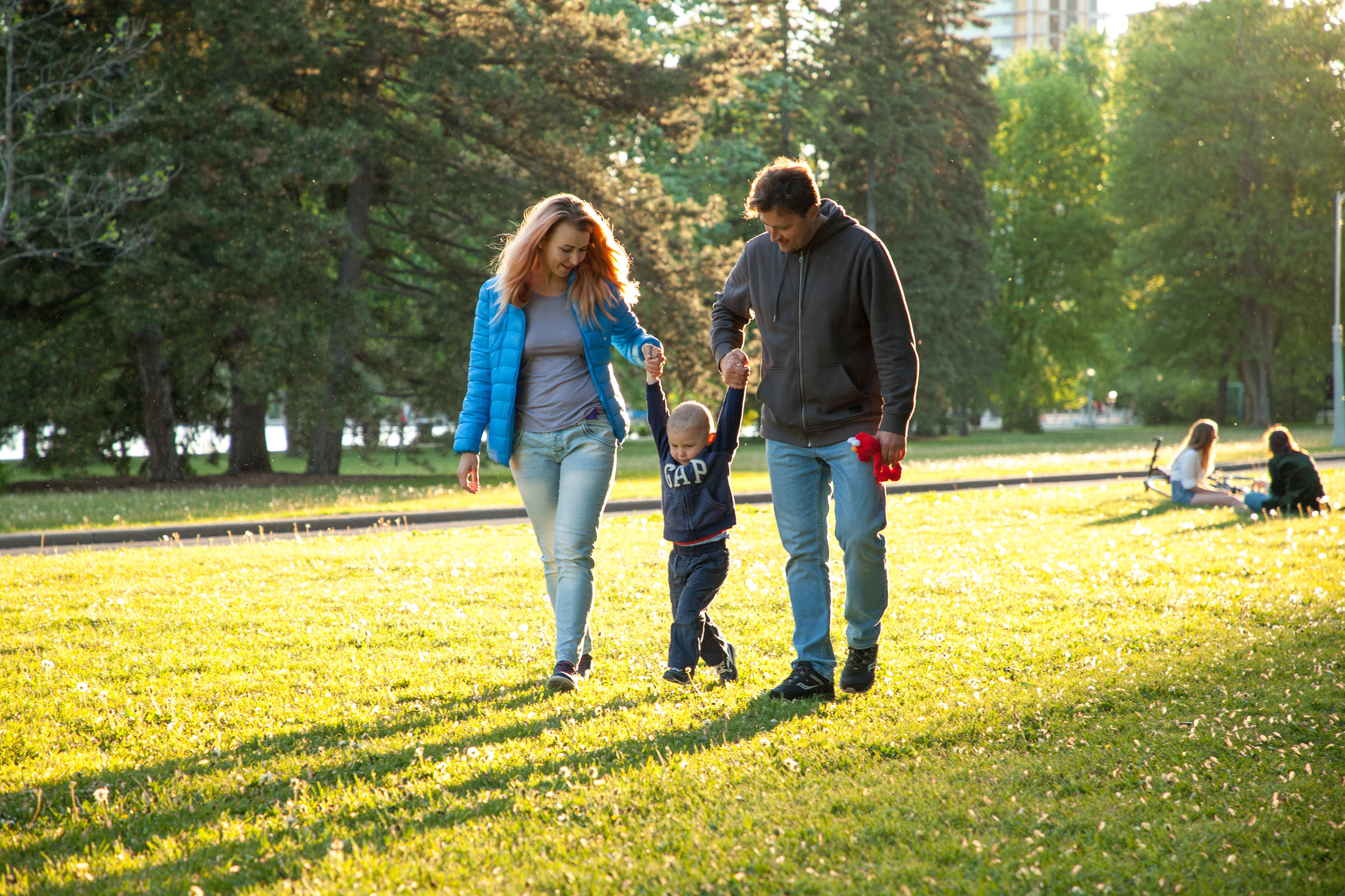 Lifestyle family portrait walking during the tulip festival at Commissioners Park, Ottawa.