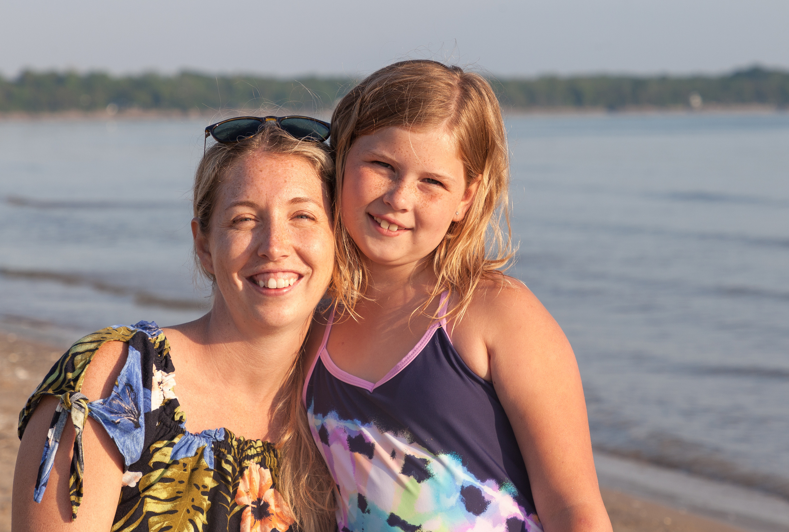 Summer family photo session under bright direct sun at Sandbanks Provincial Park beach.
