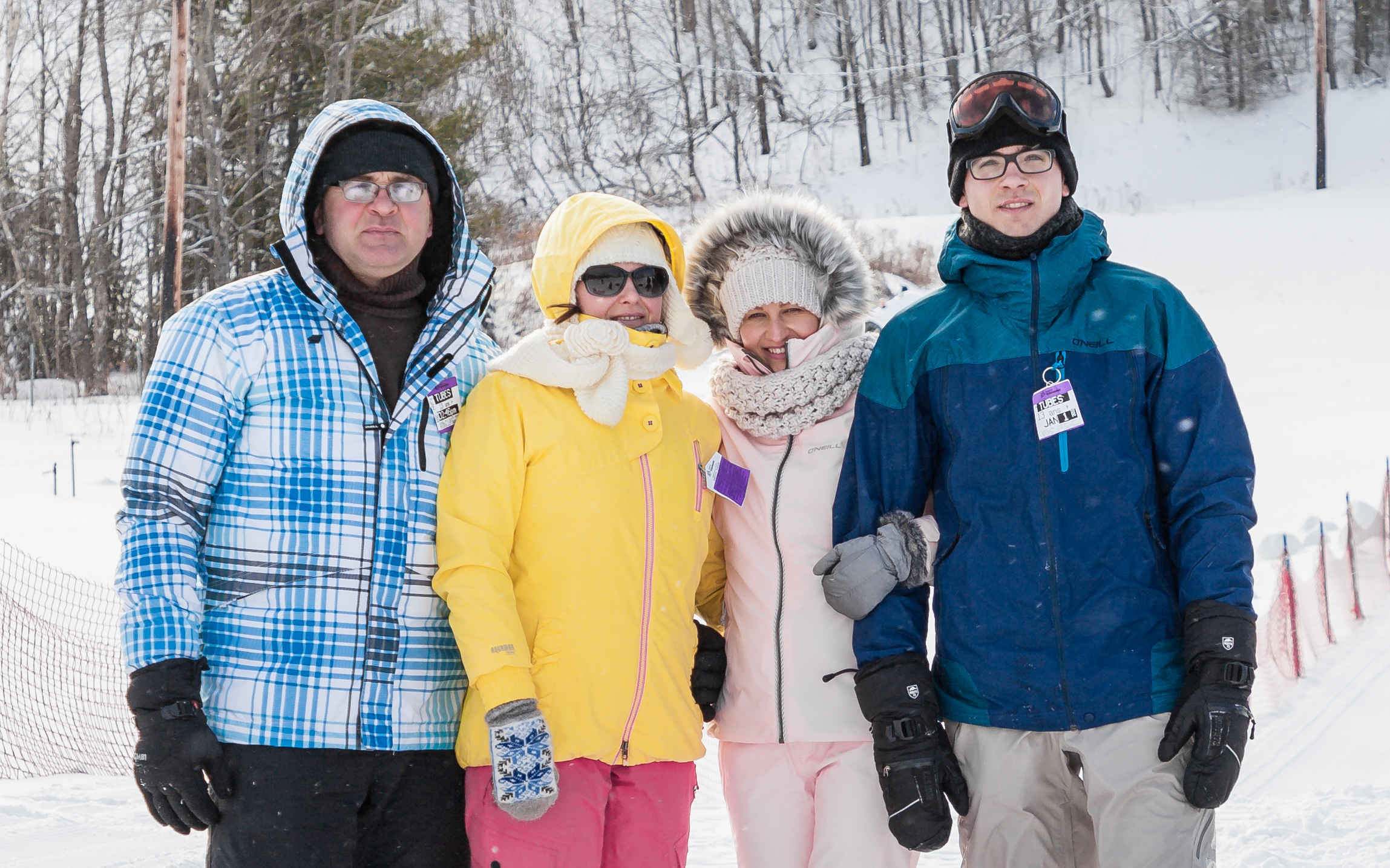 Happy family posing outdoors in winter clothing, holiday photography, Kingston, ON.