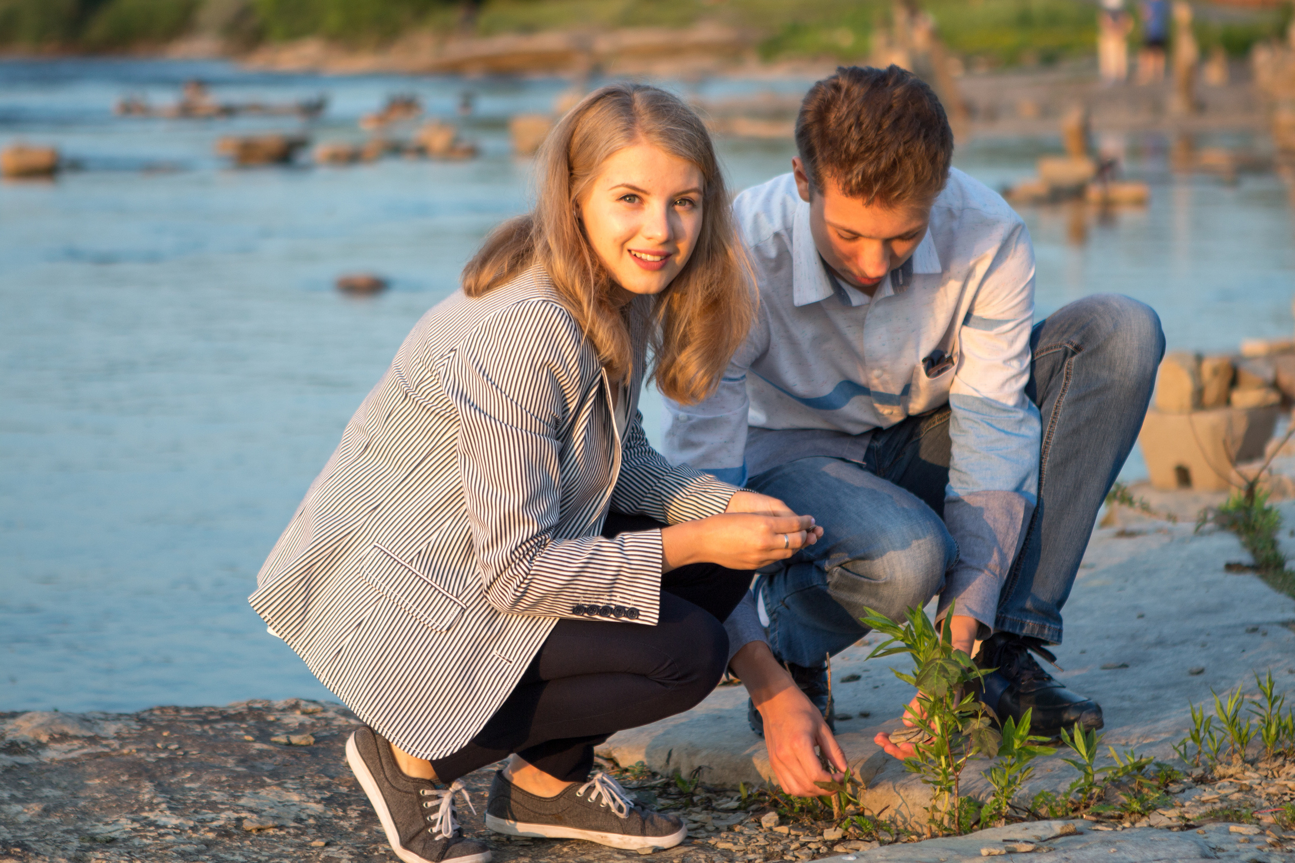 Couples lifestyle portrait on the shoreline at sunset, Kingston Ontario.