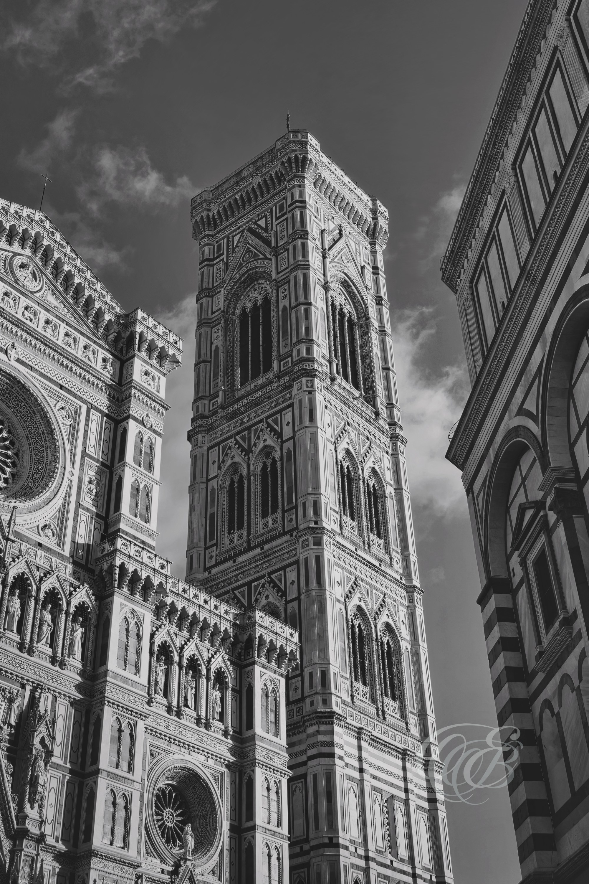 ITALY – FLORENCE — Campanile of Santa Maria del Fiore Bell Tower Matte Black and White — Gothic bell tower designed by Giotto with later contributions by Andrea Pisano and Francesco Talenti, showing detailed marble façade and vertical architectural structure next to Florence Cathedral, Florence, Italy — Eduardo Bartoli Photography.