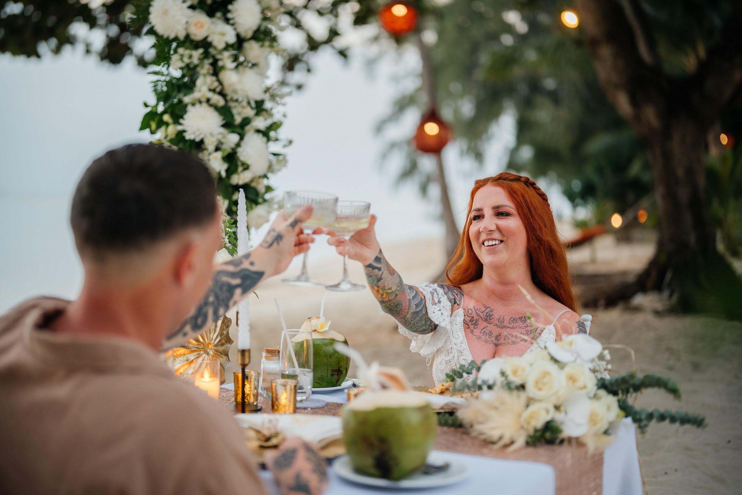 Elegant beach wedding setup on Koh Samui, Thailand with bride, groom, flowers and stunning sea backdrop