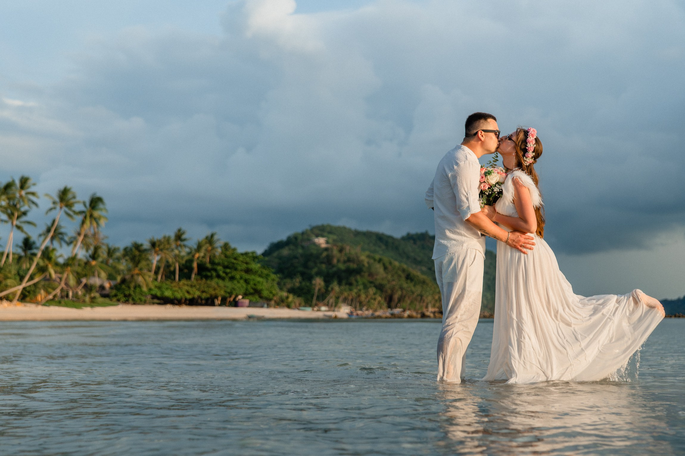 Bride and groom exchanging vows on a private sunset beach