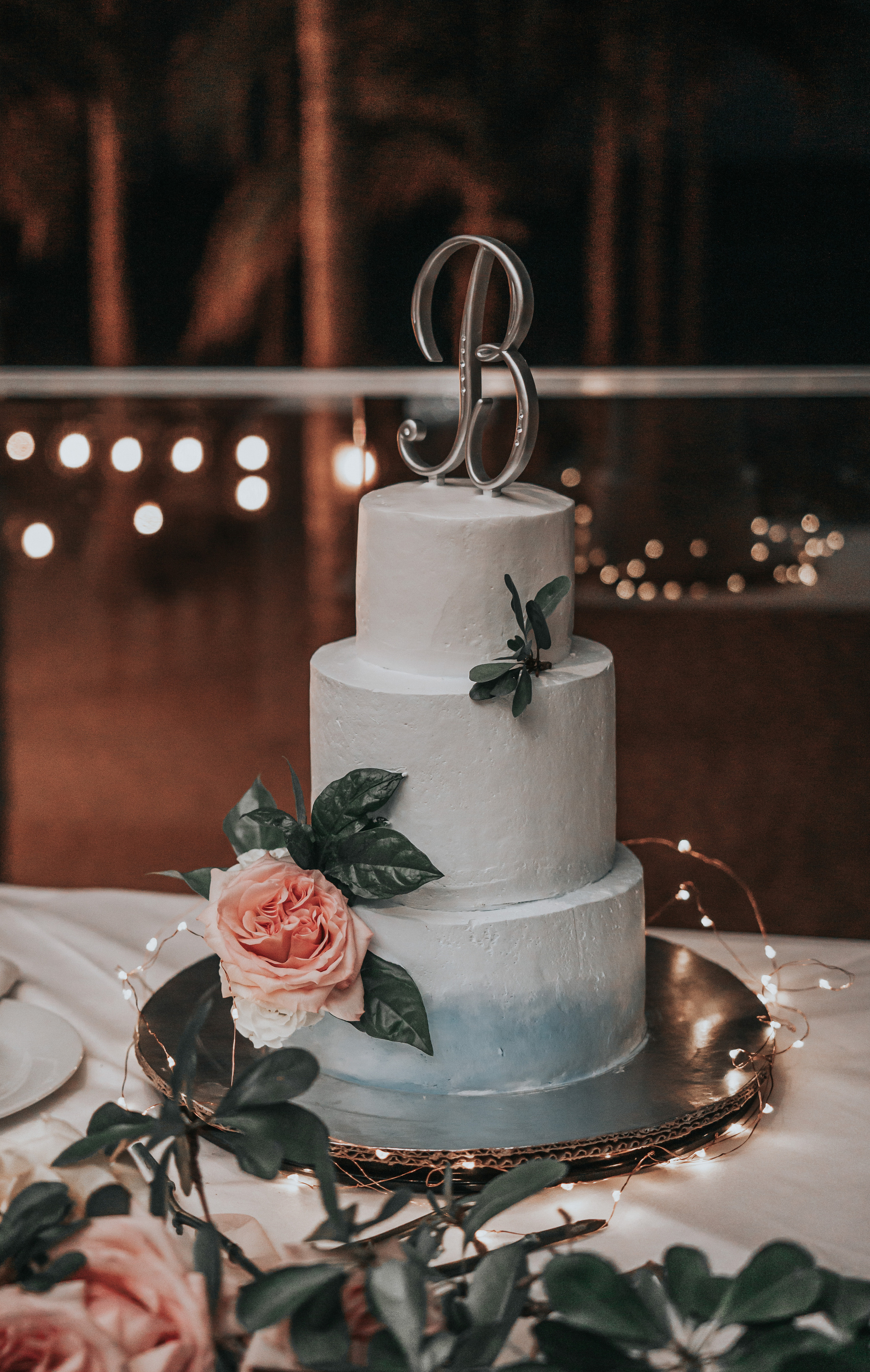 Luxury beach wedding cake with golden stand and floral design photography in Cabo