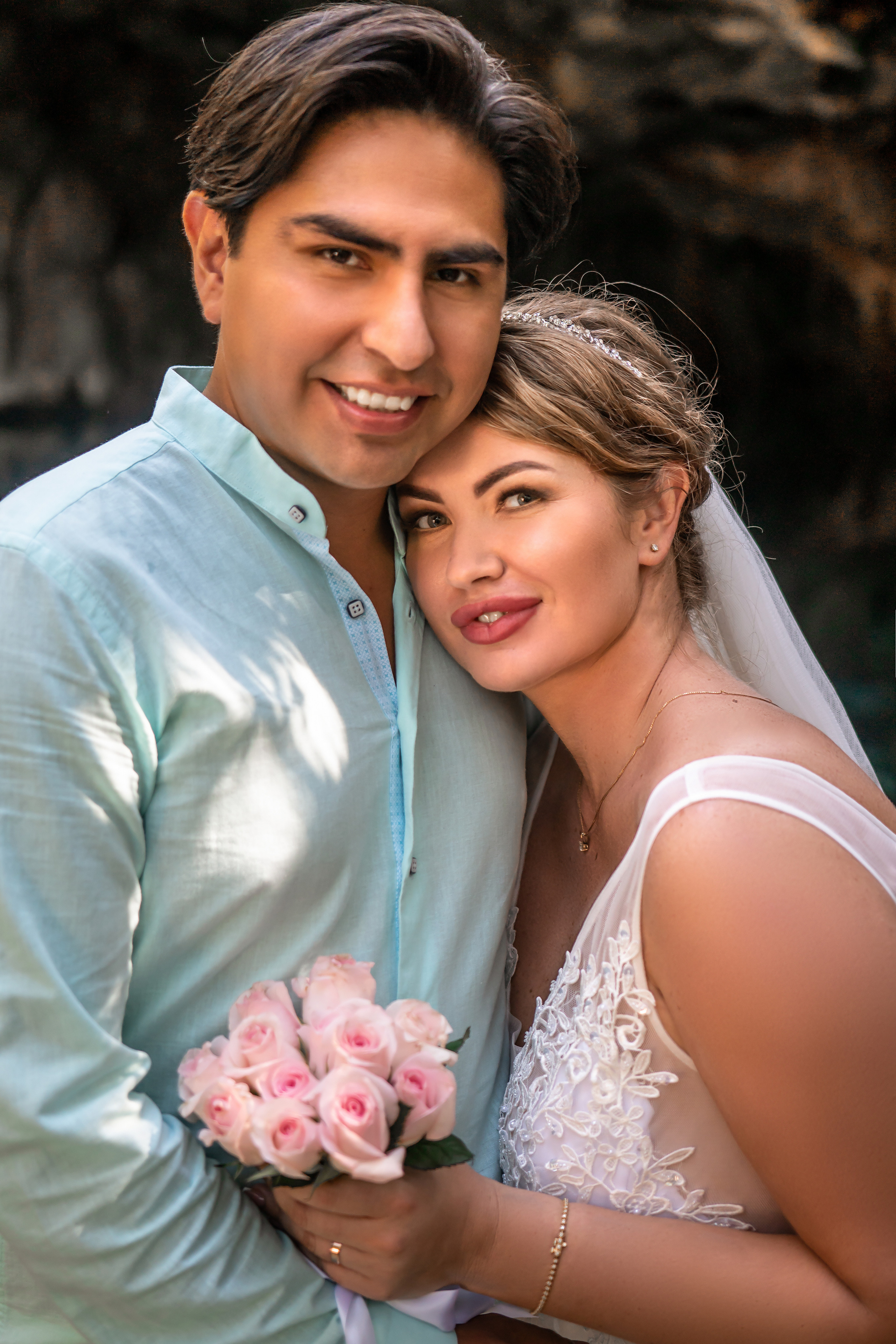 Bride and groom embracing in Riviera Maya cave lagoon